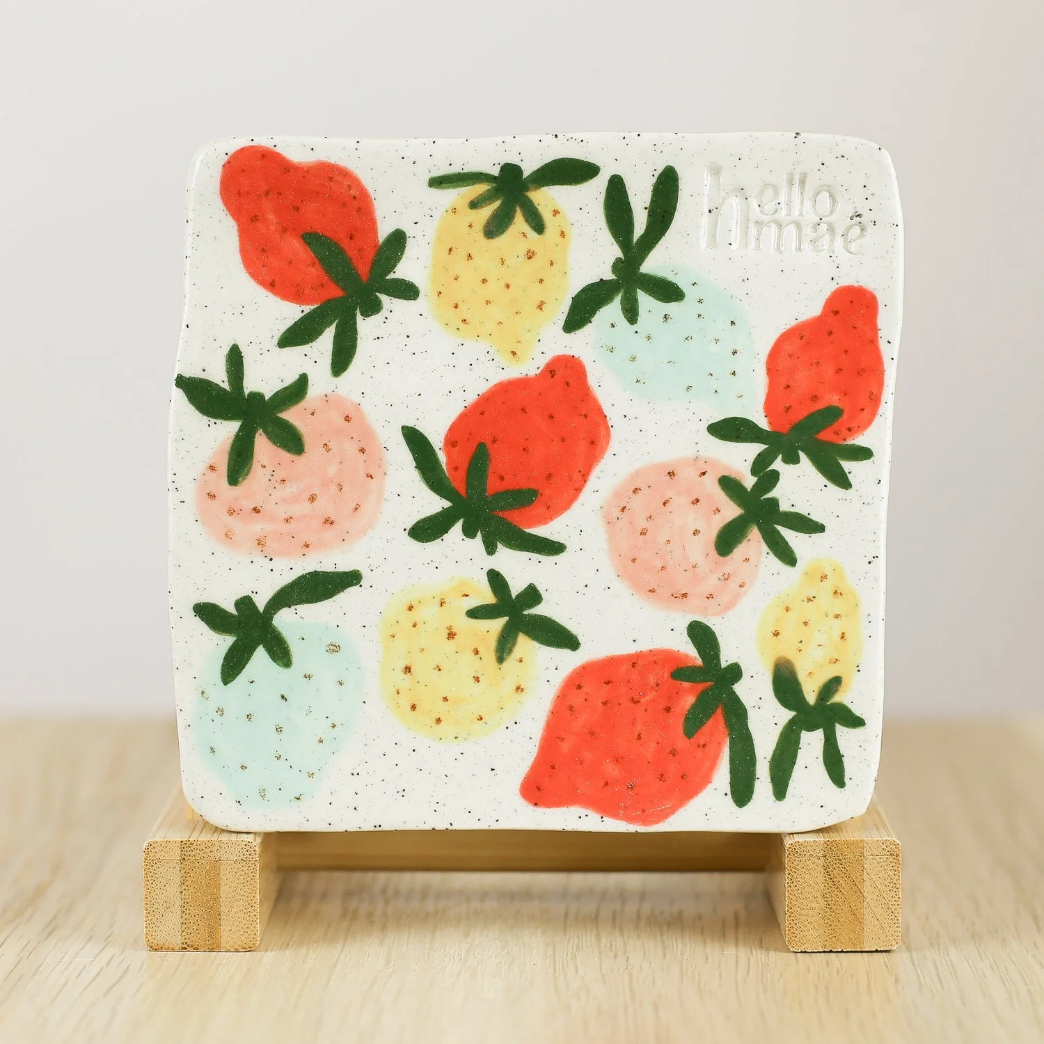 Handmade ceramic coaster with colourful strawberries and cork backing, 11cm by helloame