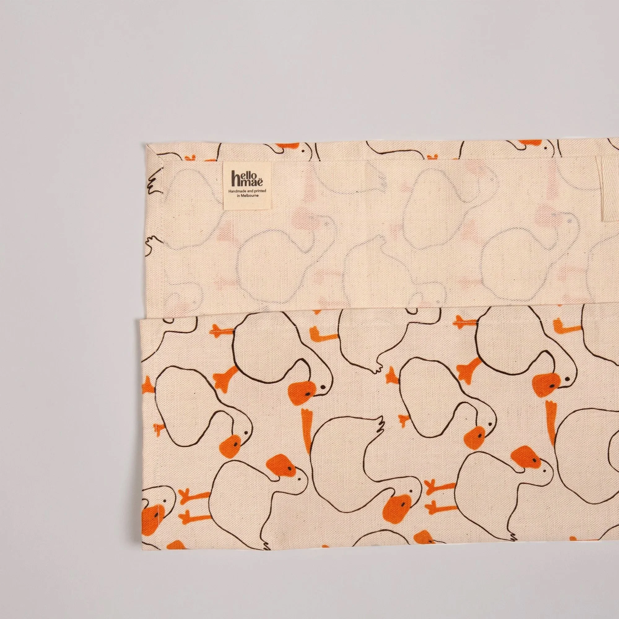Colourful duck tea towel featuring a playful print of hand-drawn ducks and garden-inspired details.