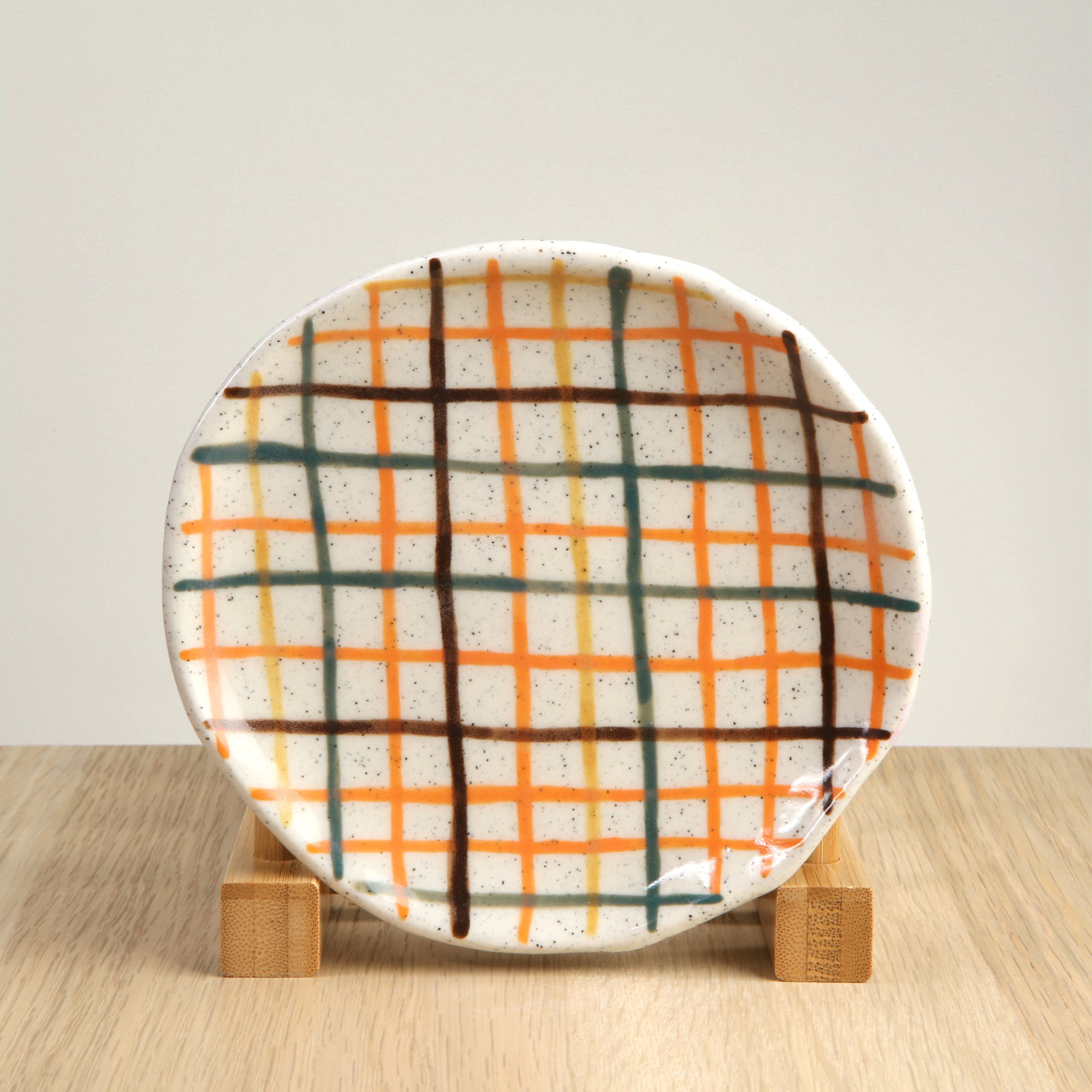 13.5cm saucer featuring yellow, orange, green and brown check.