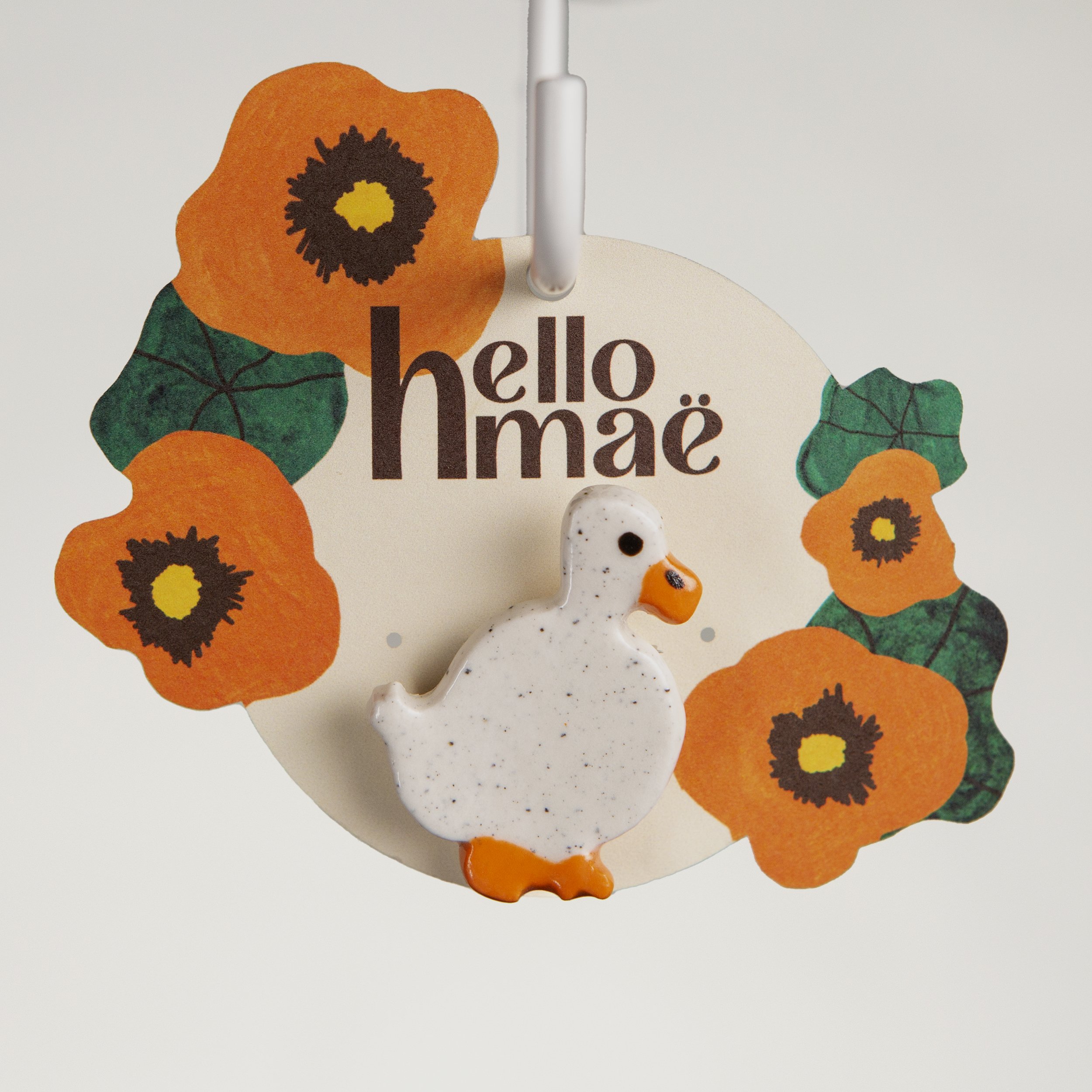 Handmade ceramic brooch with a glossy wandering white duck, photographed on a neutral background. (Copy)
