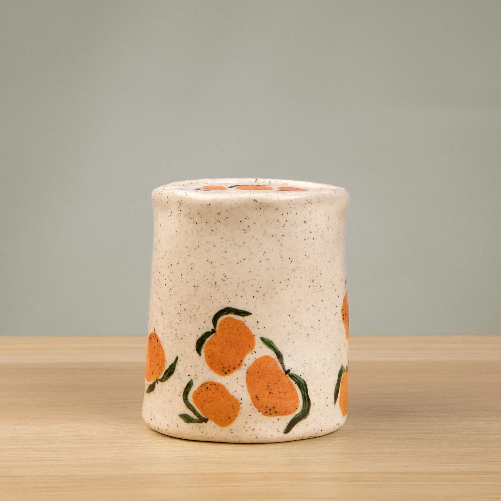 Handmade speckled ceramic mandarin travel cup decorated with sweet mandarin illustrations