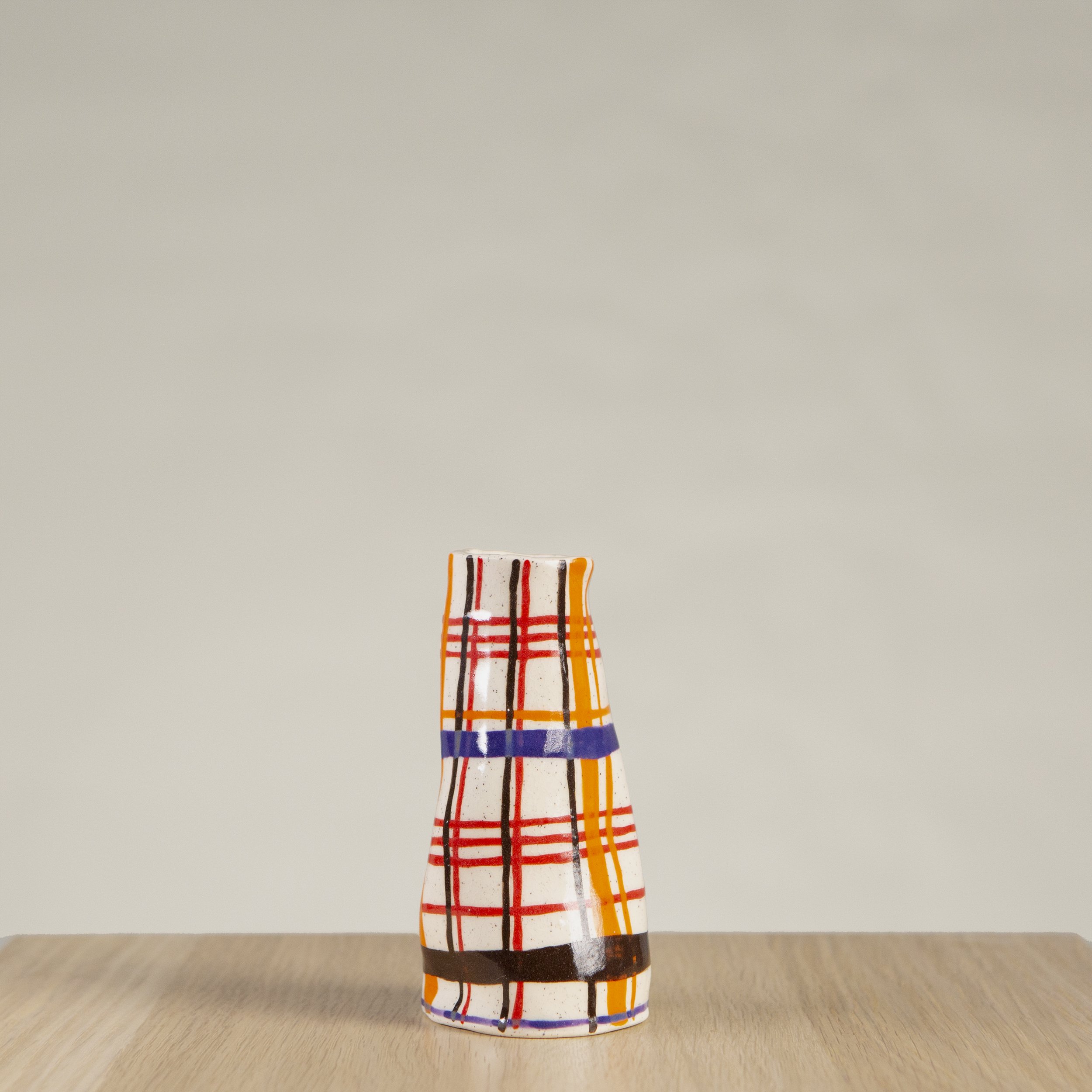 Mini ceramic vase with hand-painted orange, red, blue and chocolate check artwork on speckled clay, handmade in Melbourne by hellomaë