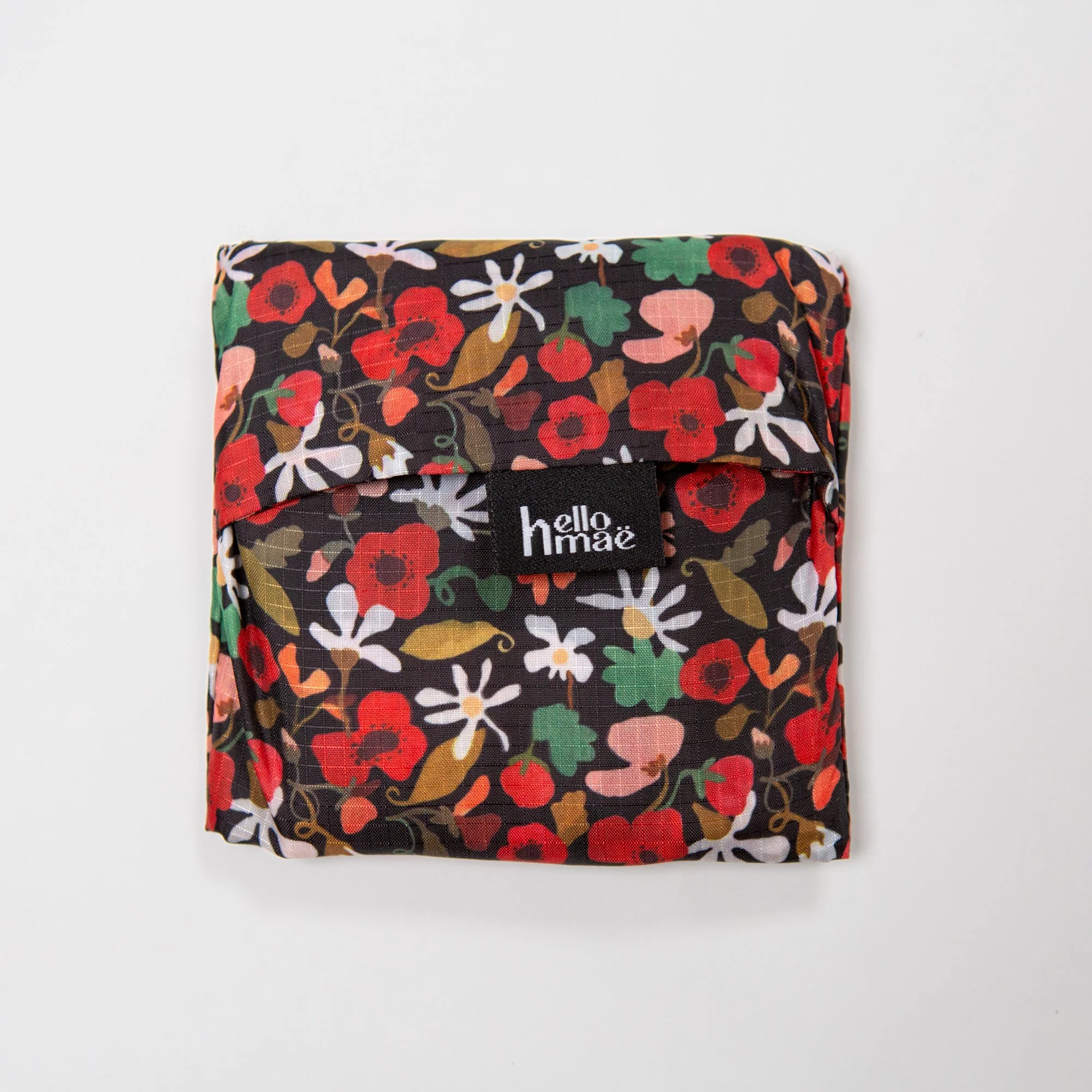 Lightweight foldable shopping bag made from recycled PET, featuring the hand-painted Flower Daze  print. Folds into an 11 × 11 cm pocket for easy everyday use.