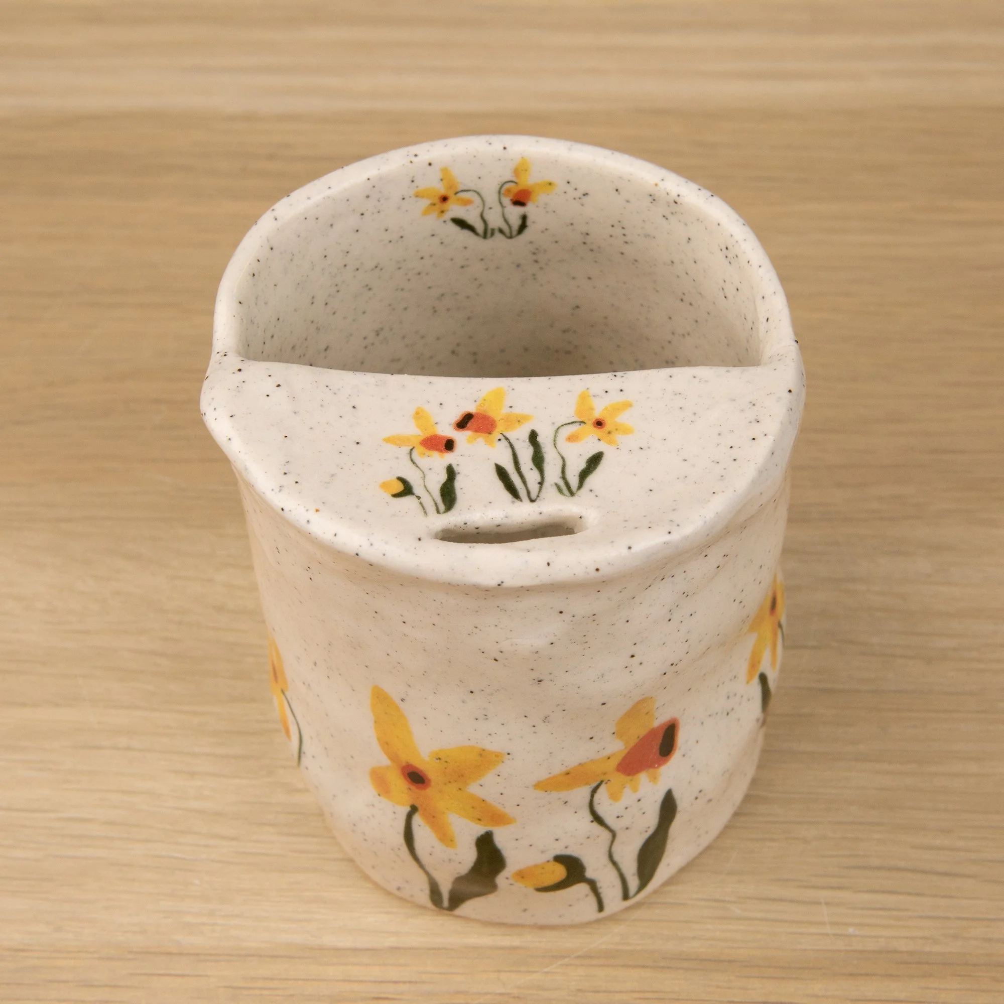 Handmade speckled ceramic daffodil travel cup decorated with sweet daffodil flowers illustrations