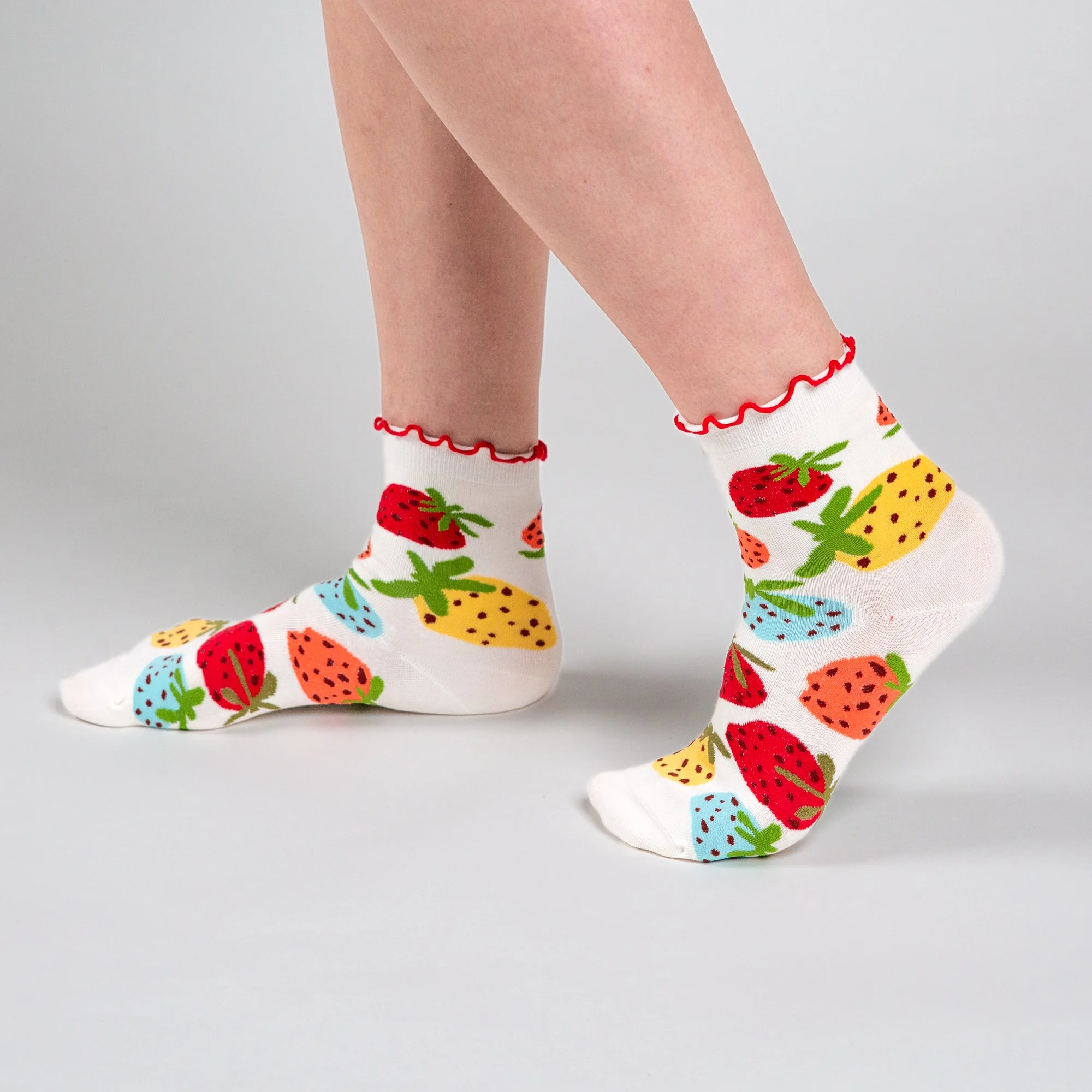 Soft ankle socks featuring the hand-painted Strawberry Dream print and a playful red frill. Comfortable, colourful and perfect for everyday wear.