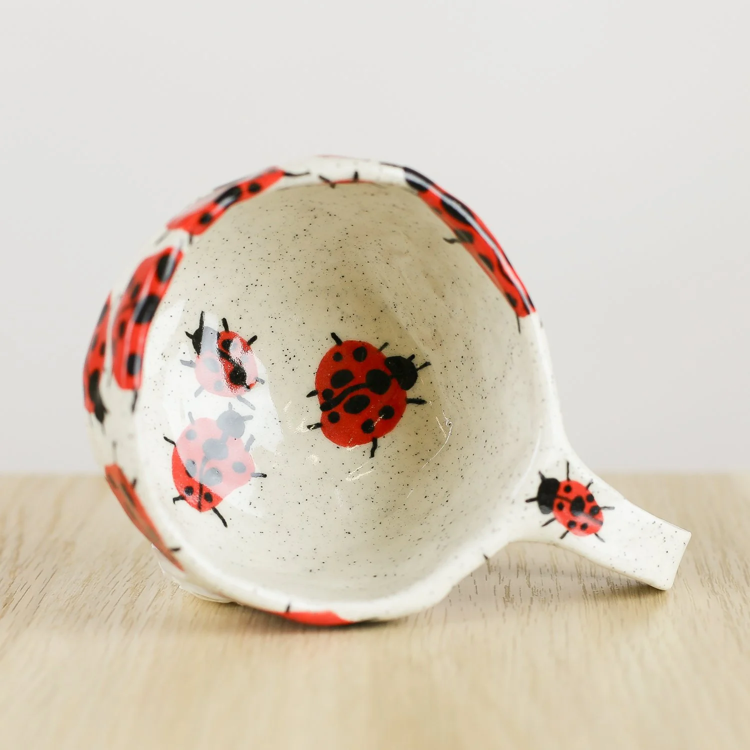 andmade ceramic cup with hand-painted ladybugs. Holds 150ml. A unique, whimsical coffee cup perfect for everyday rituals and thoughtful gifts.