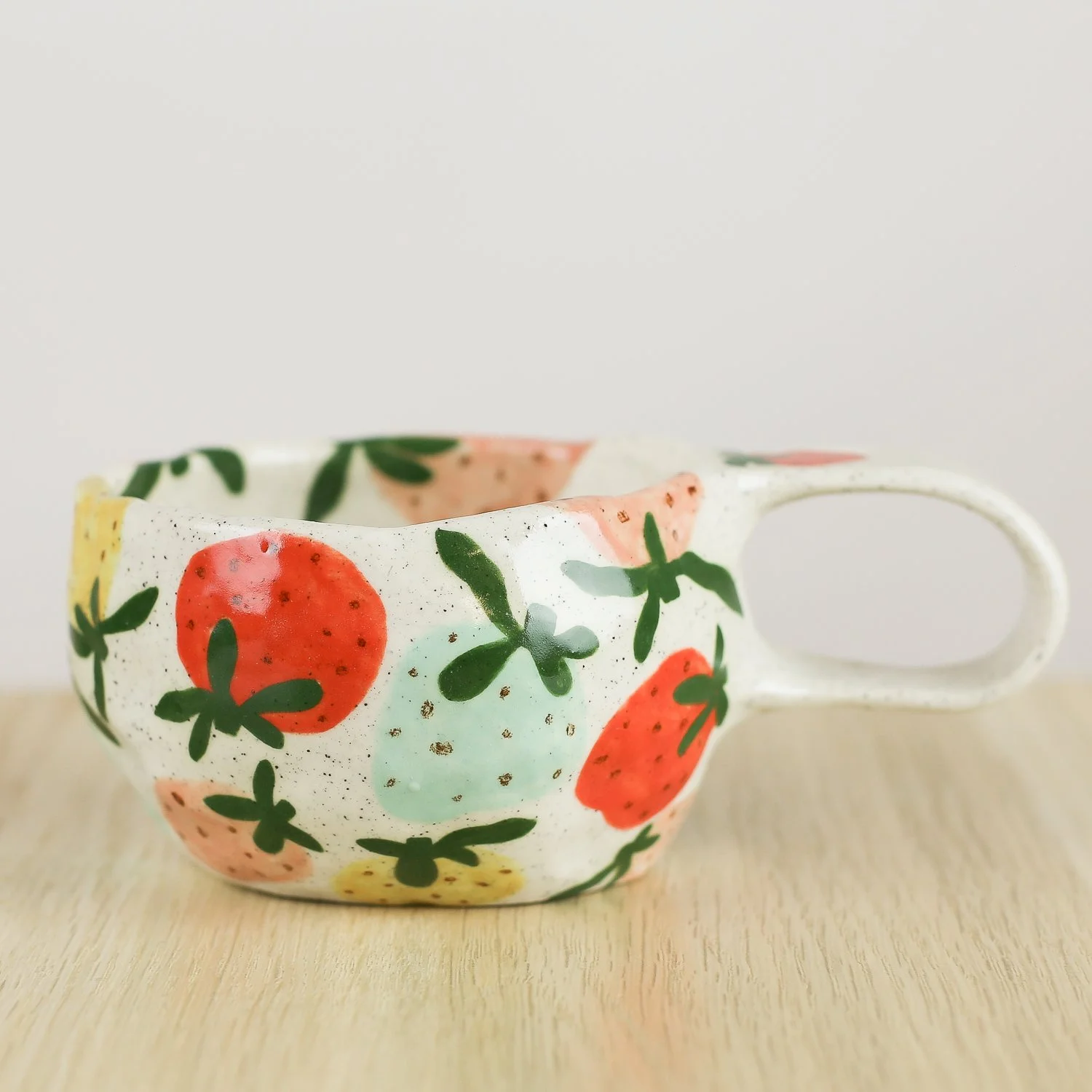 Handmade ceramic mug with colourful strawberries in red pink yellow and blue, 300ml mug by Hello Mae