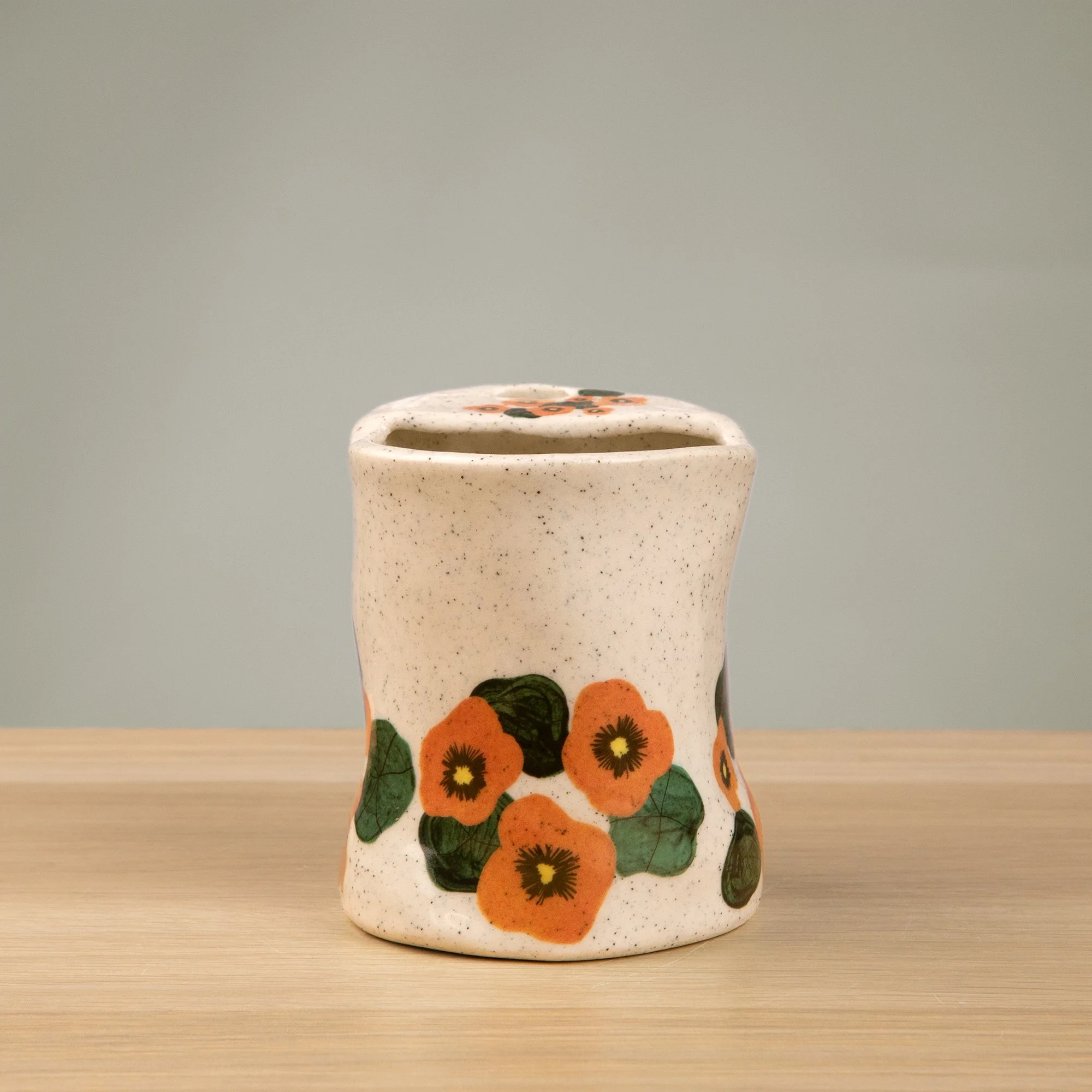 Handmade speckled ceramic nasturtium travel cup decorated with sweet nasturtiums