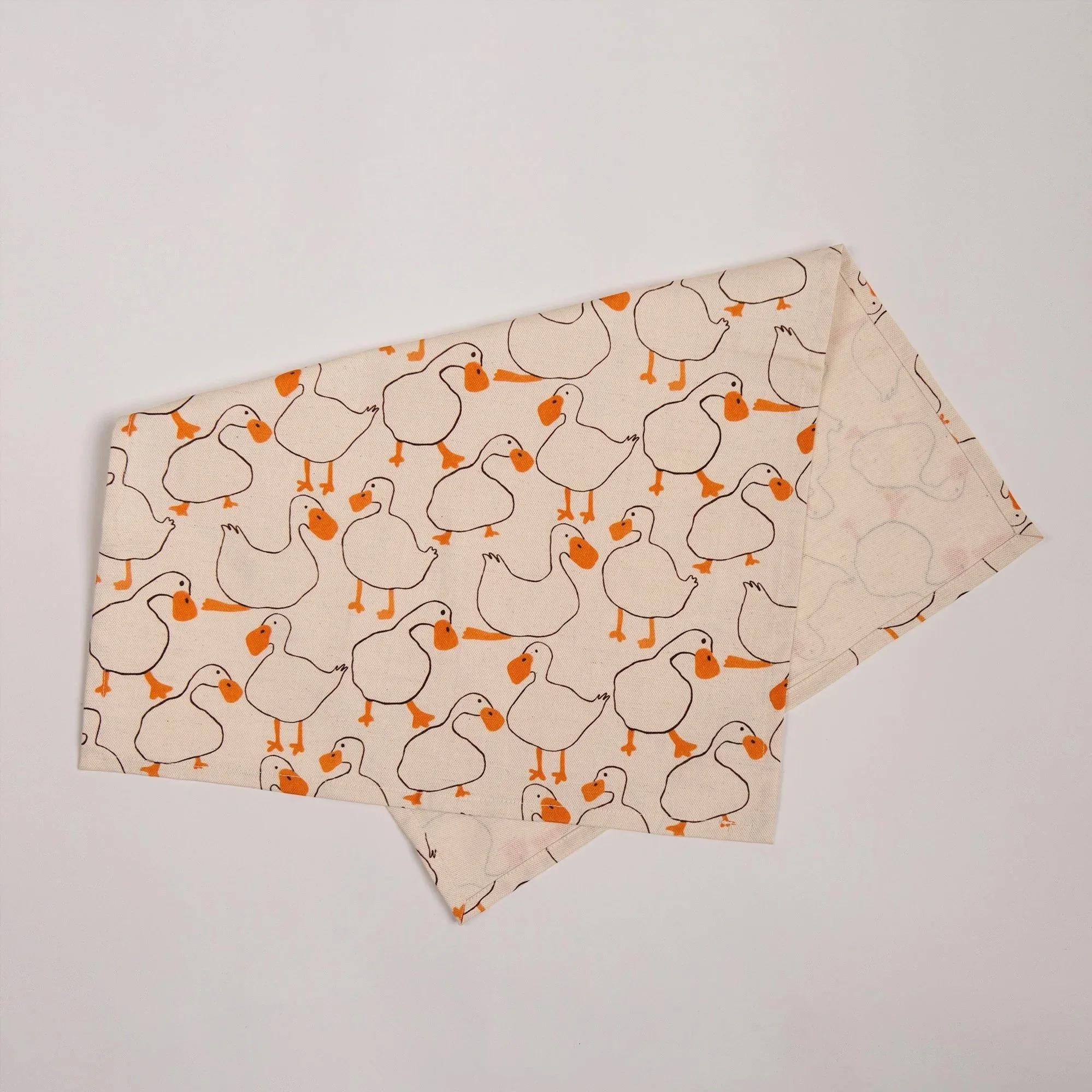 Colourful duck tea towel featuring a playful print of hand-drawn ducks and garden-inspired details.