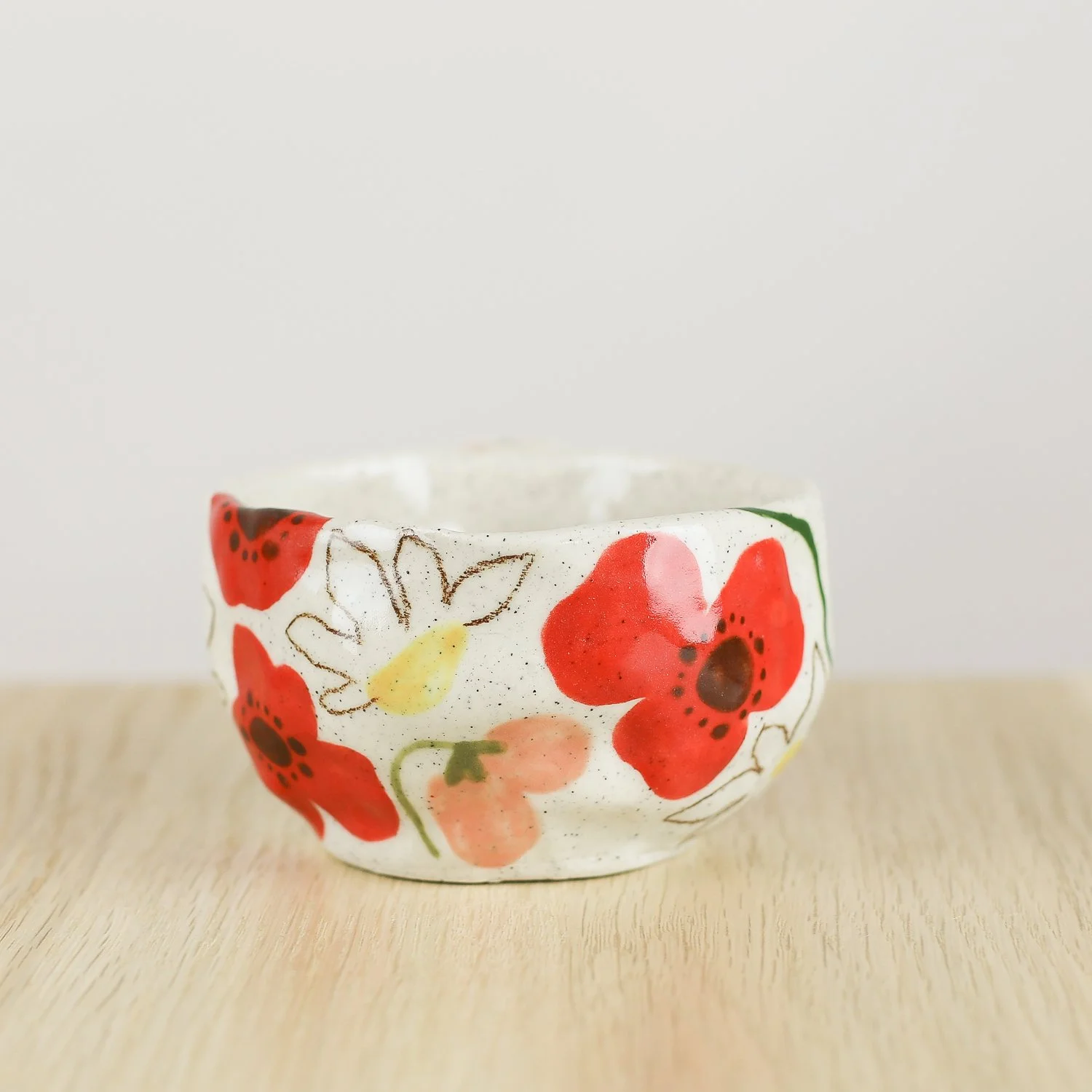 Handmade ceramic cup with hand-painted poppies, daisies and sweet pea flowers. Holds 150ml. A unique floral coffee cup for everyday rituals.