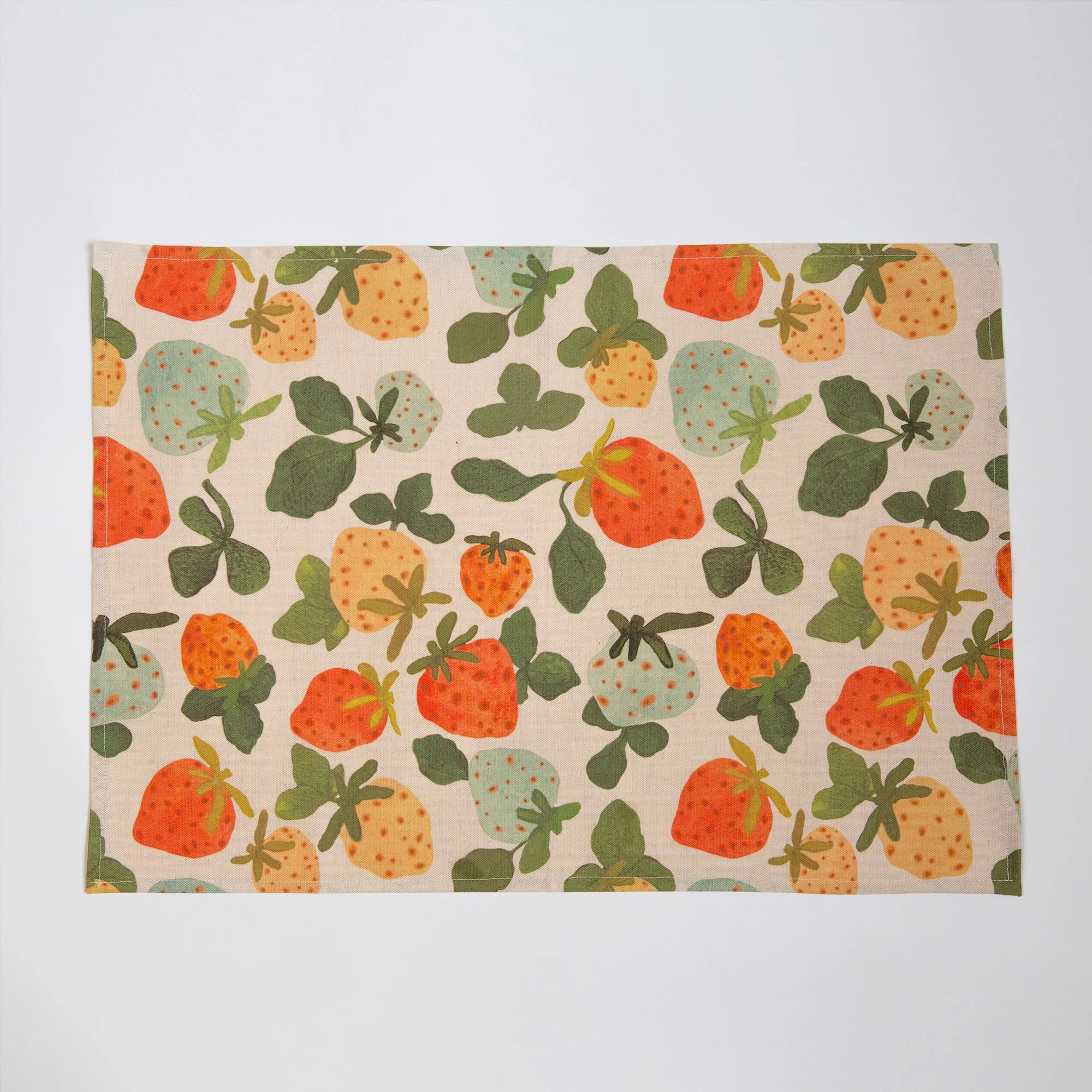 Colourful strawberry tea towel featuring a playful print of yellow, red, pink and blue hand-drawn strawberries.