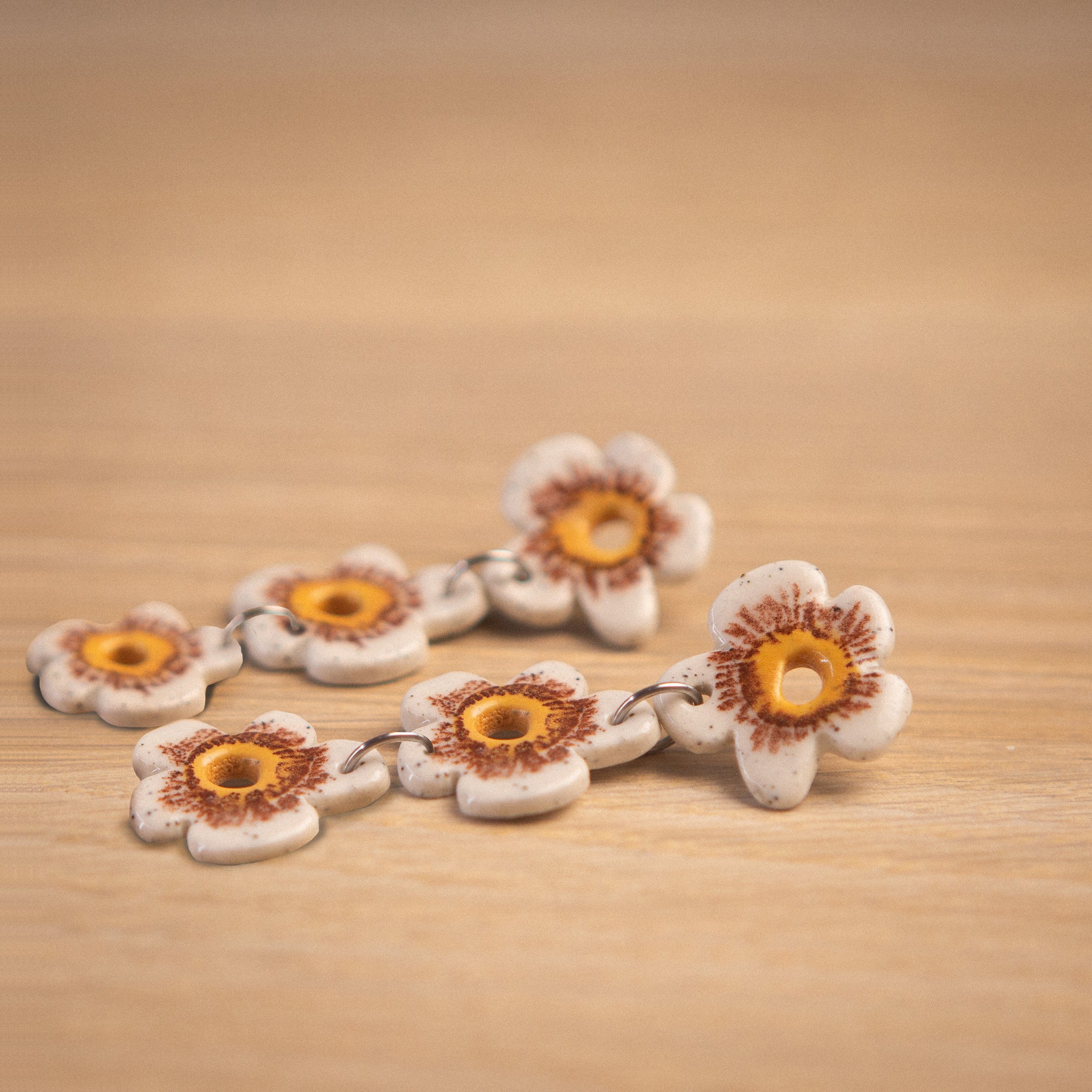 Three-tier handmade ceramic earrings featuring 3 white flowers designed by Hellomae