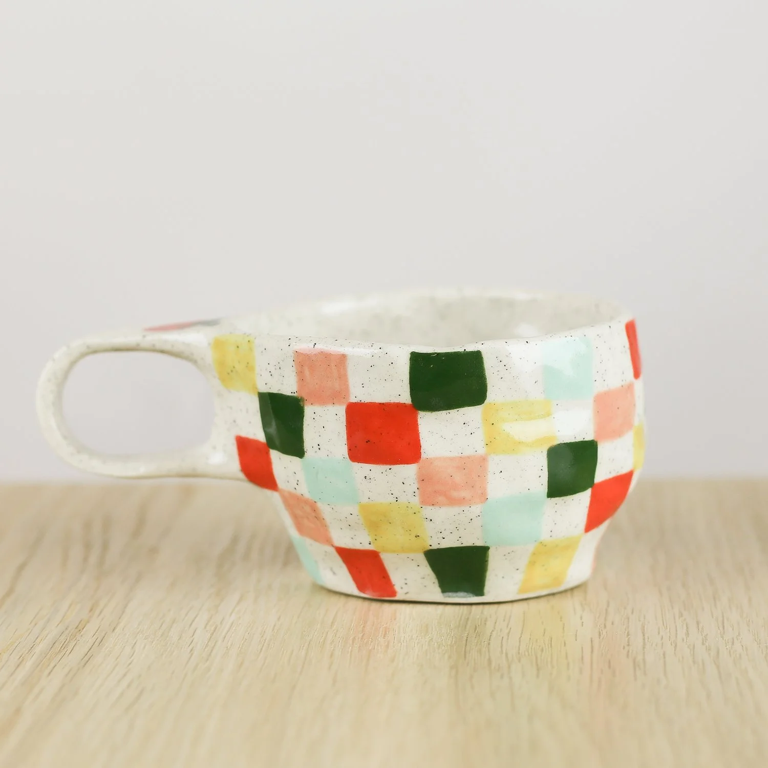 Handmade ceramic cup with colourful check pattern in red pink yellow and blue, 150ml coffee cup by Hello Mae