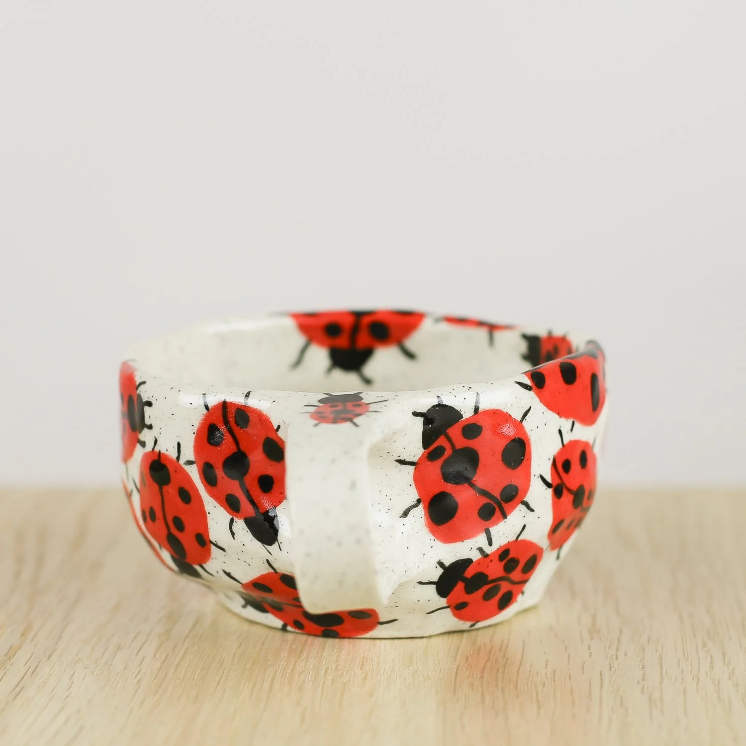 andmade ceramic cup with hand-painted ladybugs. Holds 150ml. A unique, whimsical coffee cup perfect for everyday rituals and thoughtful gifts.