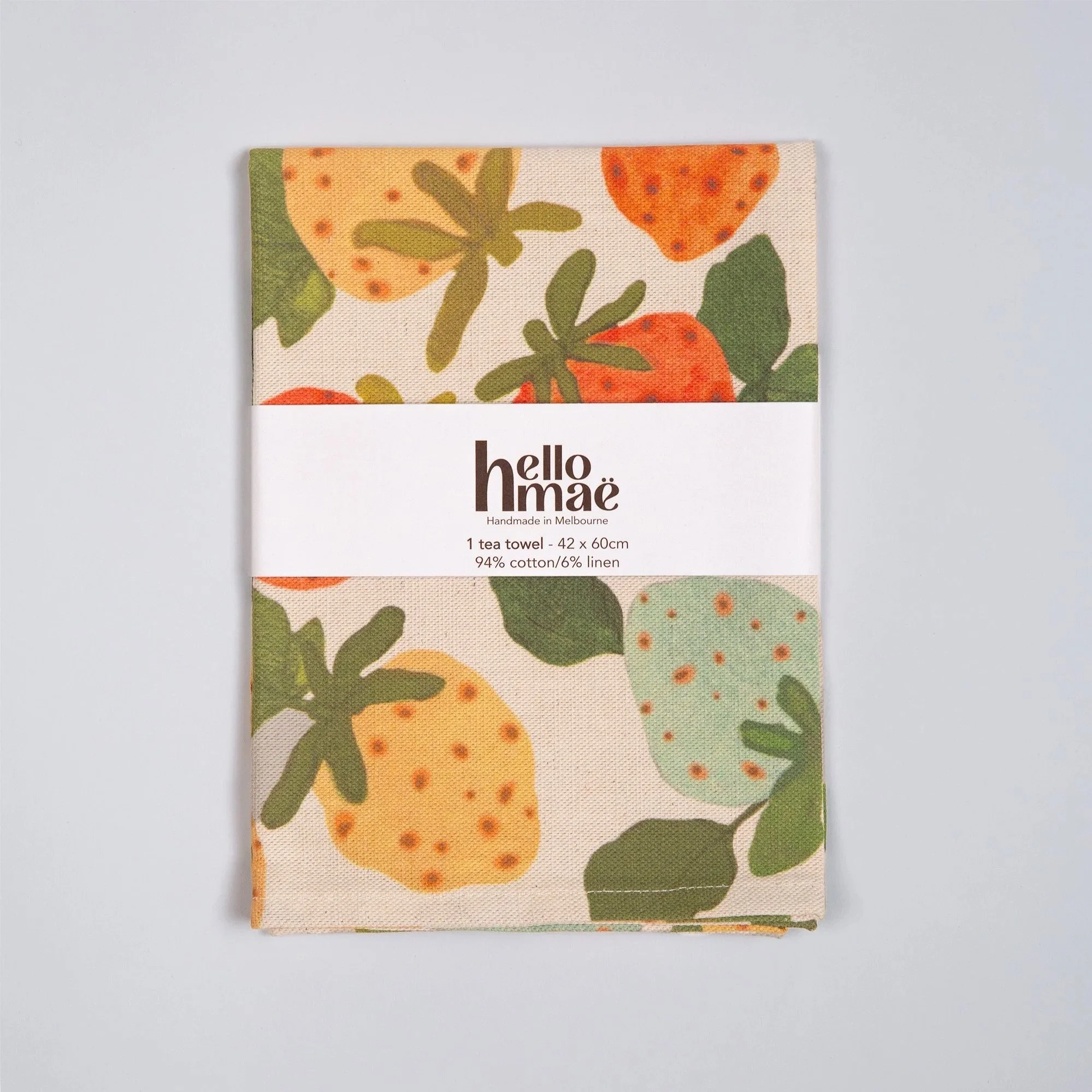 Colourful strawberry tea towel featuring a playful print of yellow, red, pink and blue hand-drawn strawberries.