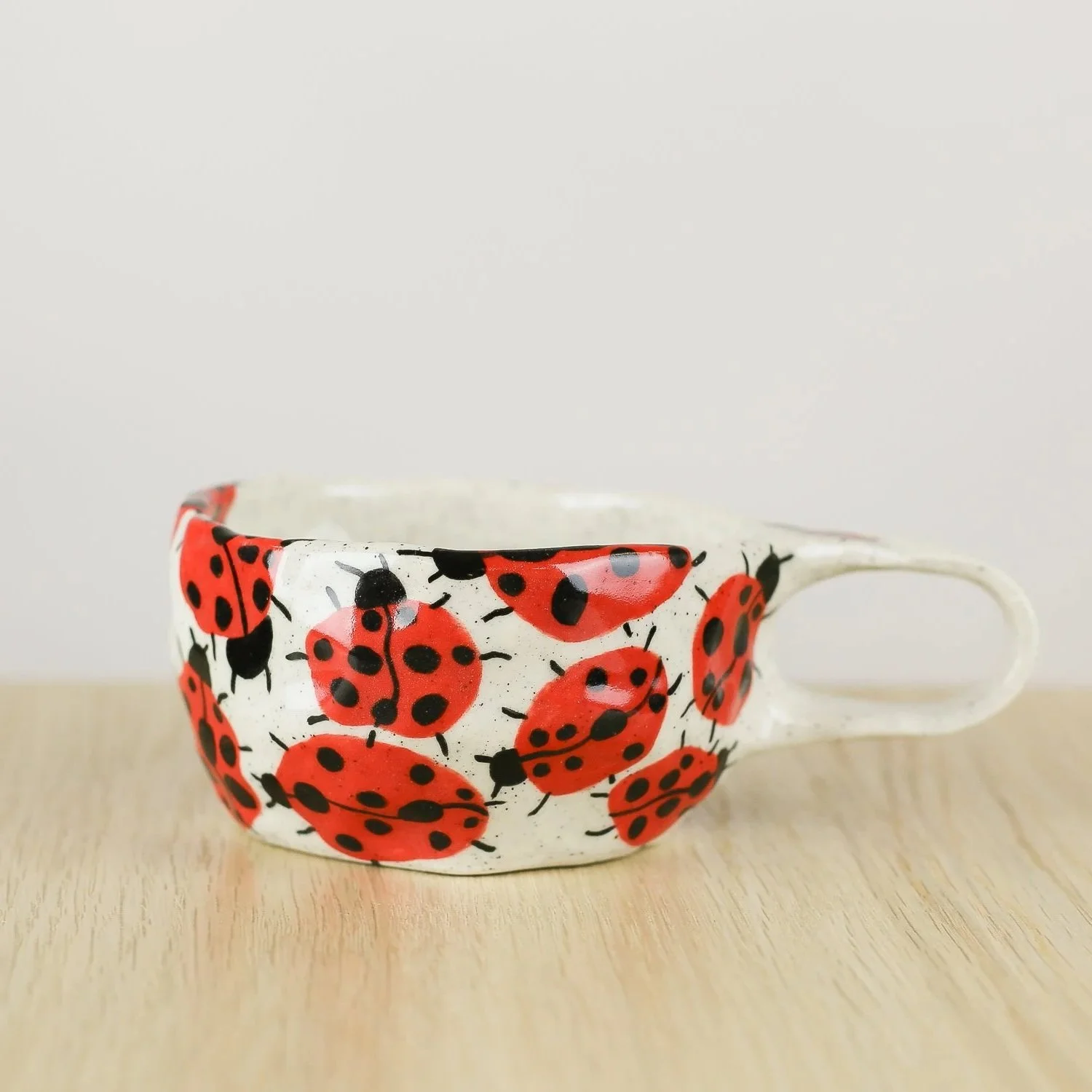andmade ceramic cup with hand-painted ladybugs. Holds 150ml. A unique, whimsical coffee cup perfect for everyday rituals and thoughtful gifts.