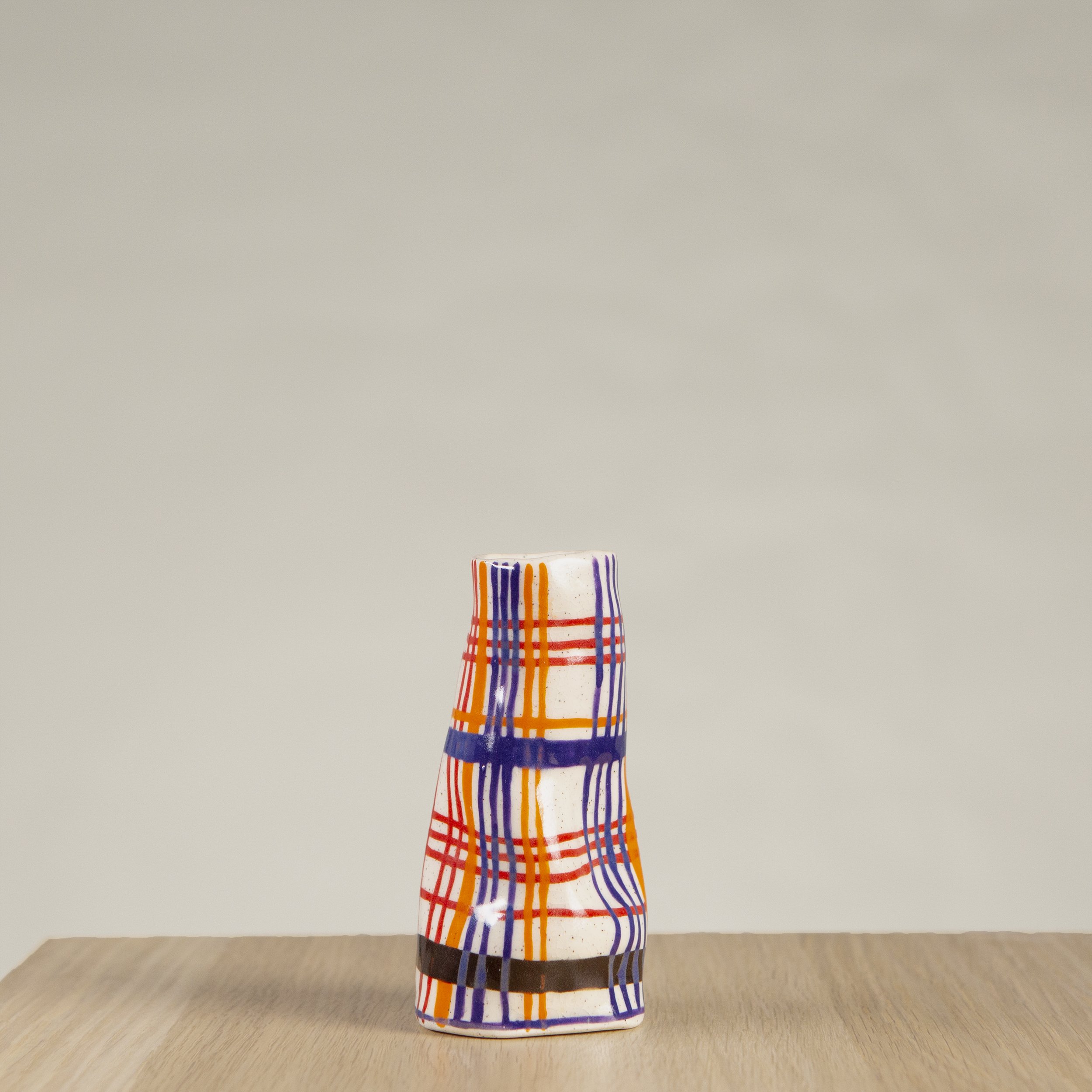 Mini ceramic vase with hand-painted orange, red, blue and chocolate check artwork on speckled clay, handmade in Melbourne by hellomaë