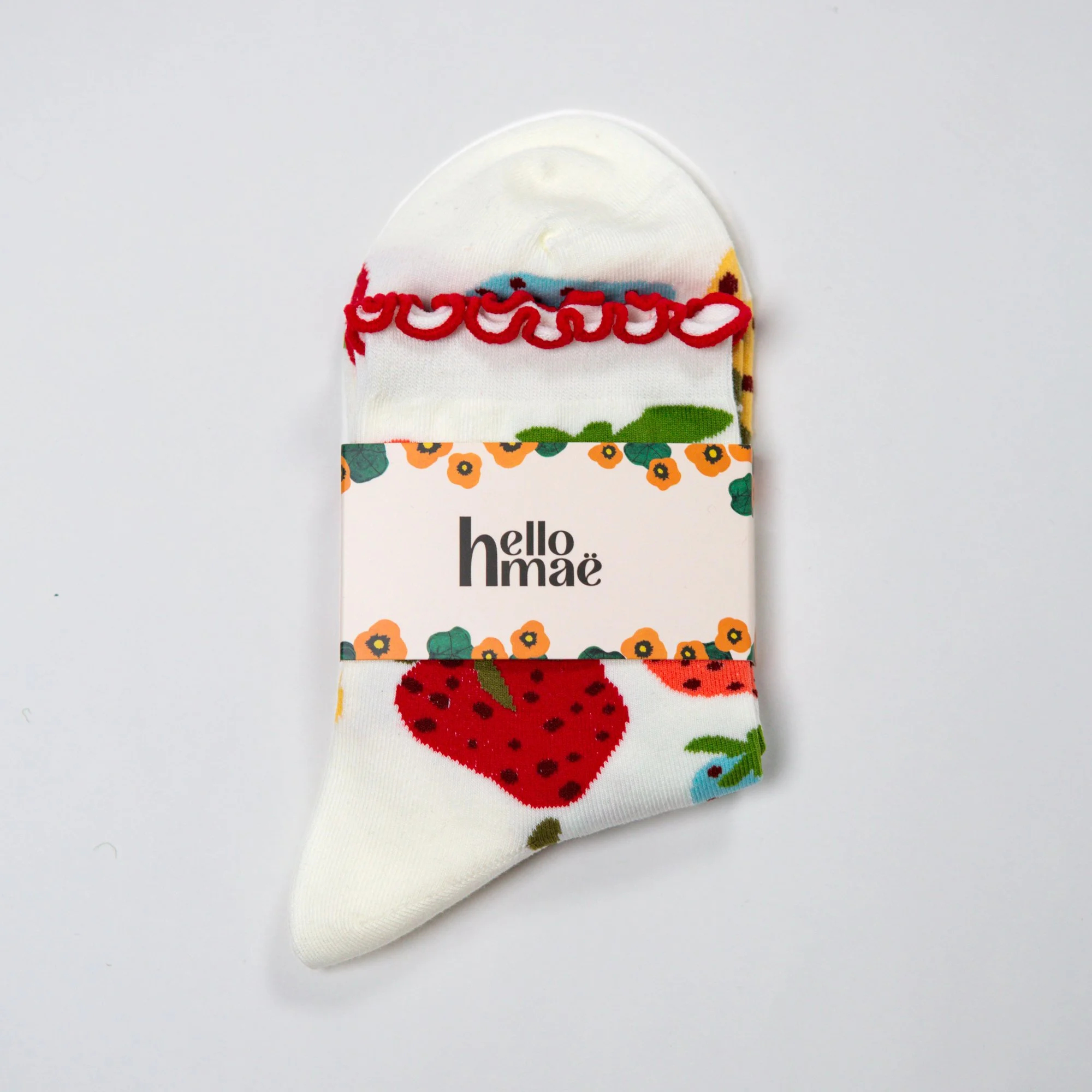 Soft ankle socks featuring the hand-painted Strawberry Dream print and a playful red frill. Comfortable, colourful and perfect for everyday wear.