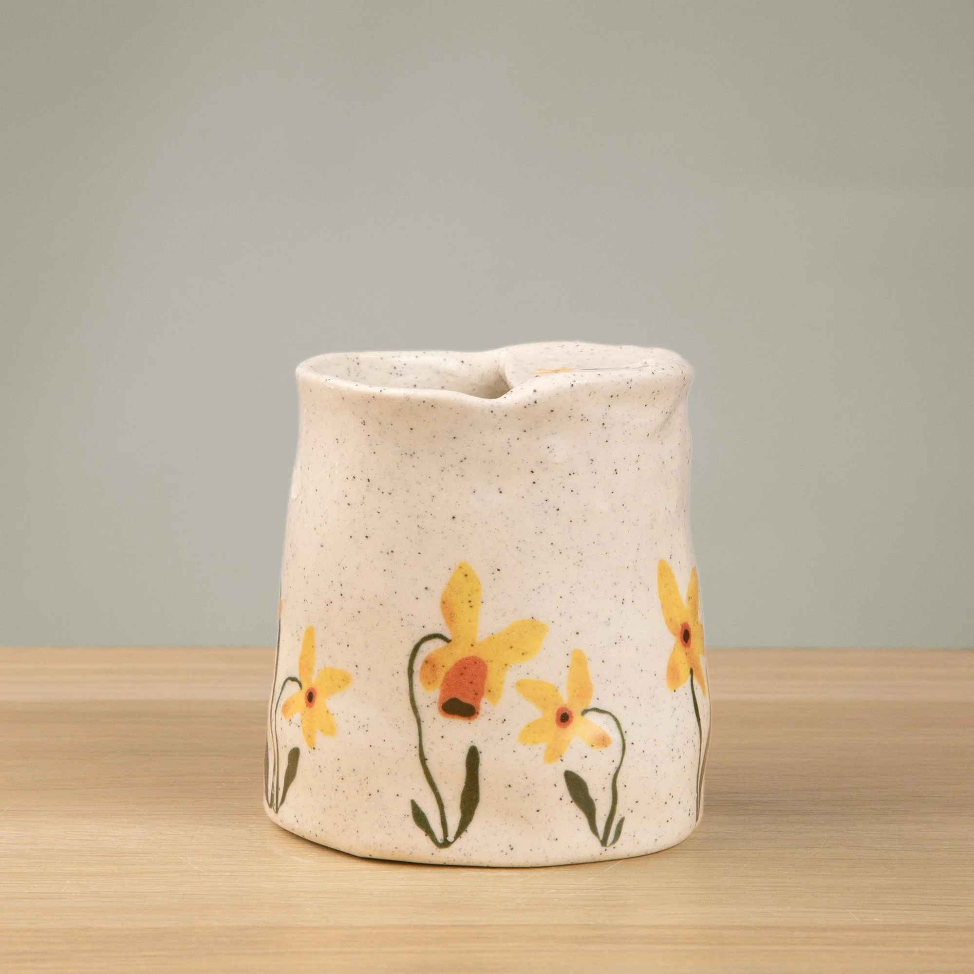 Handmade speckled ceramic daffodil travel cup decorated with sweet daffodil flowers illustrations