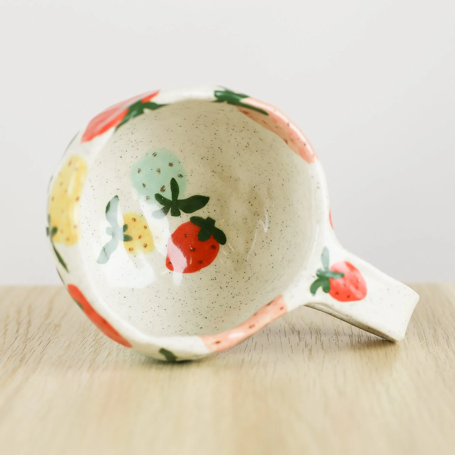 Handmade ceramic mug with colourful strawberries in red pink yellow and blue, 300ml mug by Hello Mae