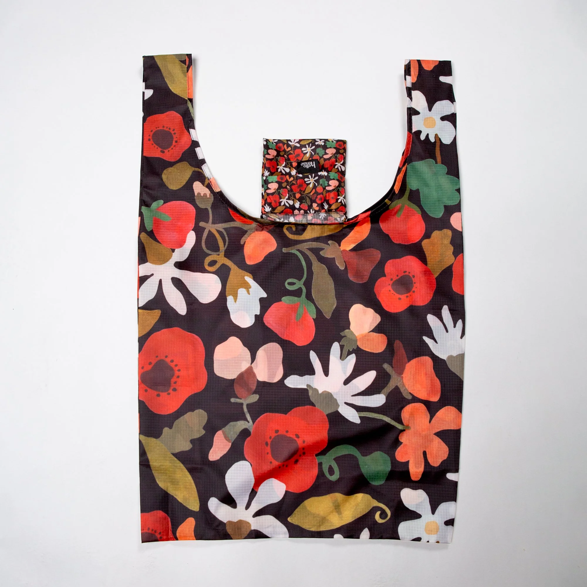 Lightweight foldable shopping bag made from recycled PET, featuring the hand-painted Flower Daze  print. Folds into an 11 × 11 cm pocket for easy everyday use.