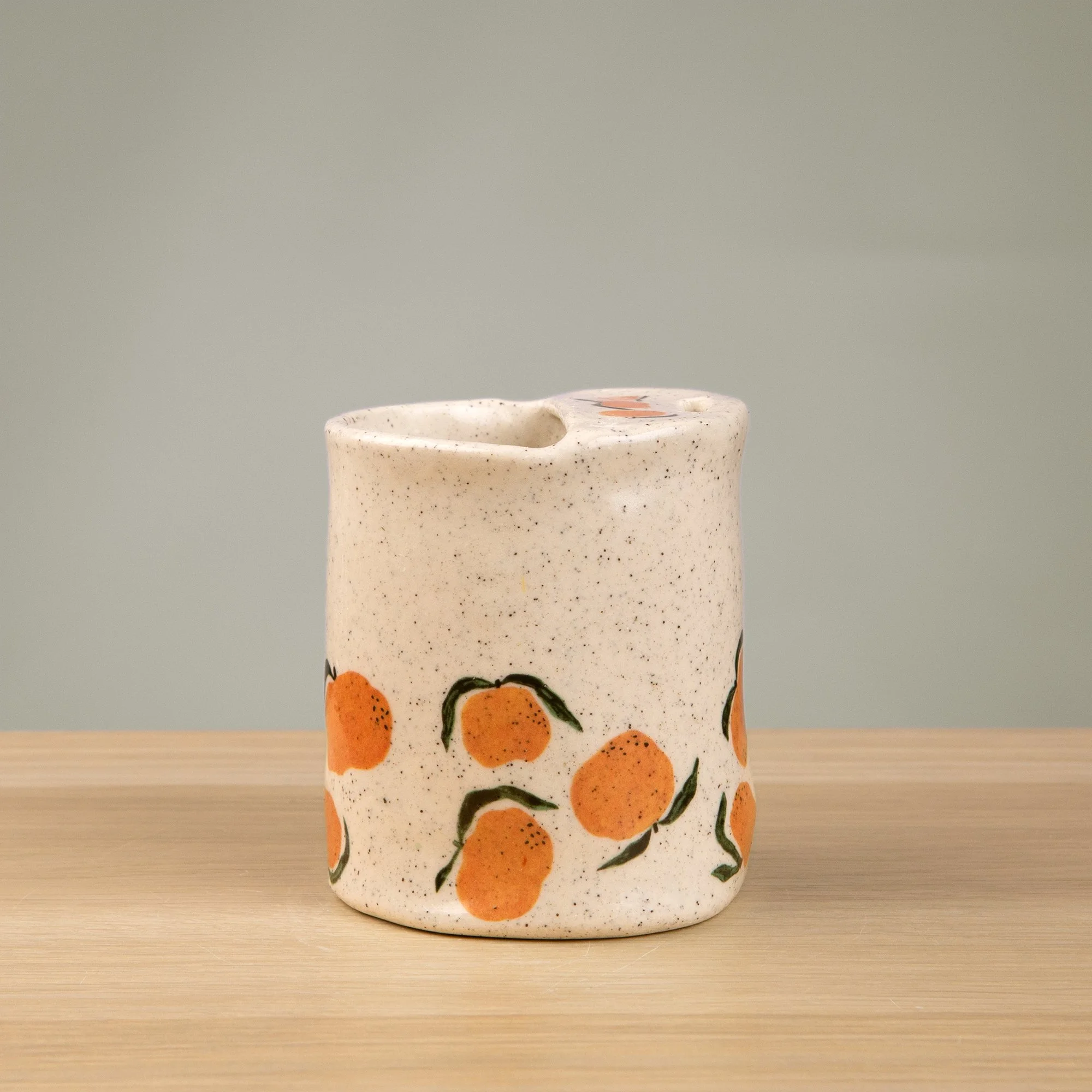 Handmade speckled ceramic mandarin travel cup decorated with sweet mandarin illustrations