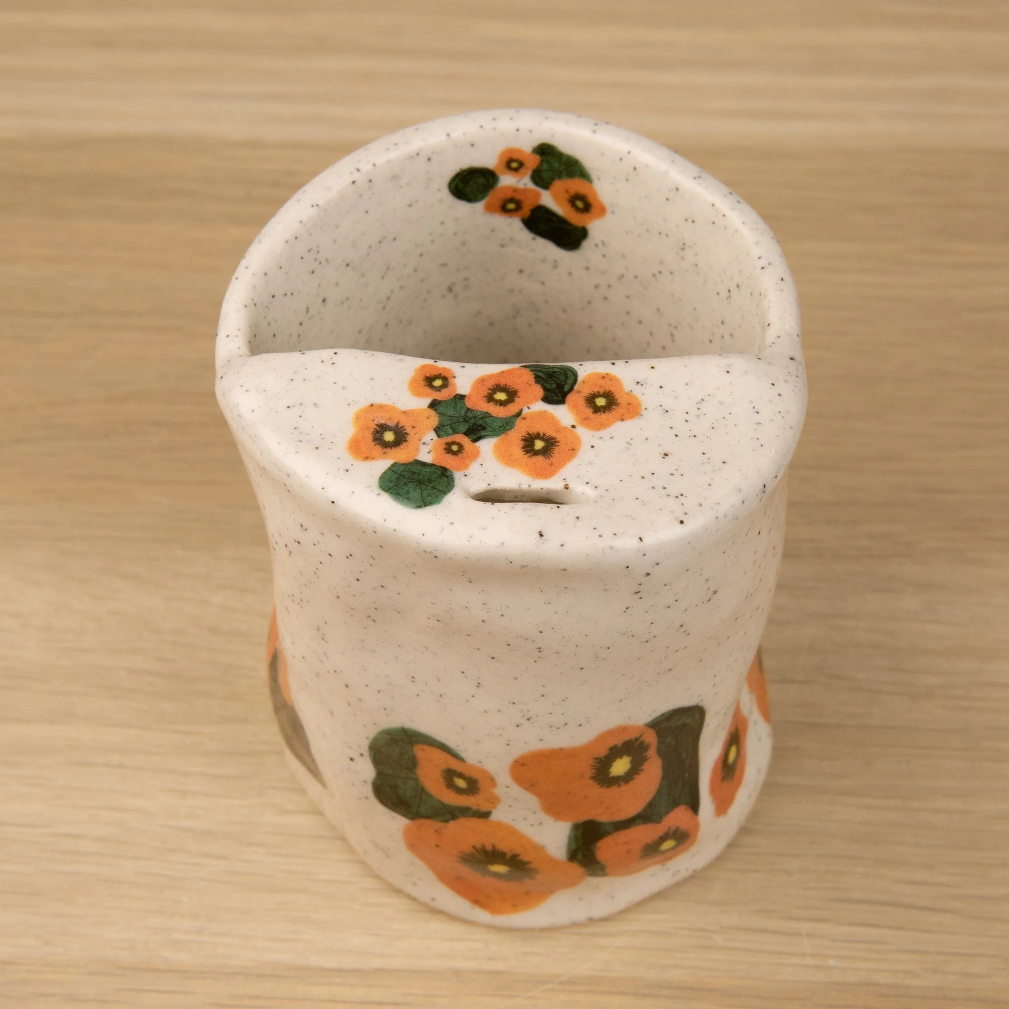 Handmade speckled ceramic nasturtium travel cup decorated with sweet nasturtiums