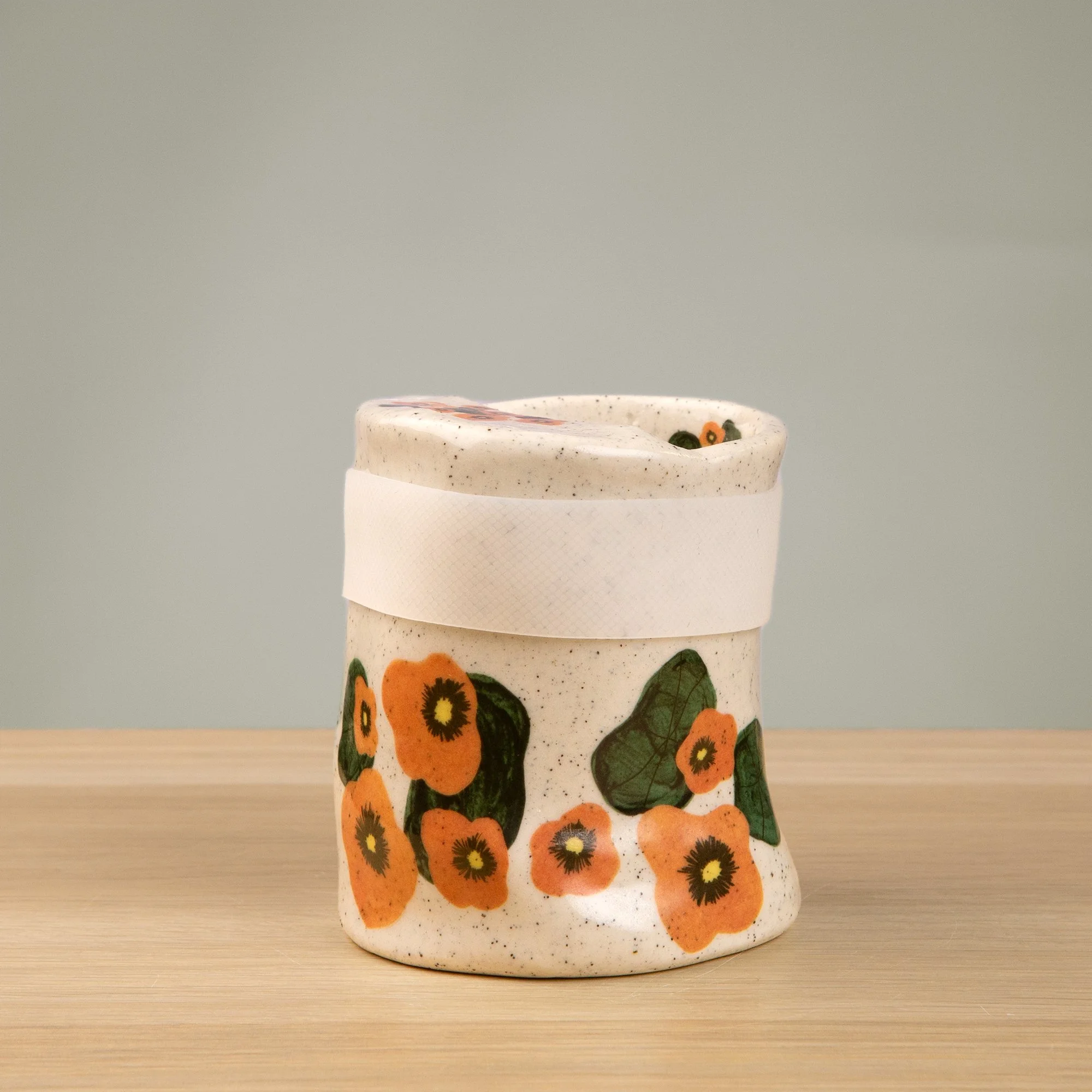 Handmade speckled ceramic nasturtium travel cup decorated with sweet nasturtiums