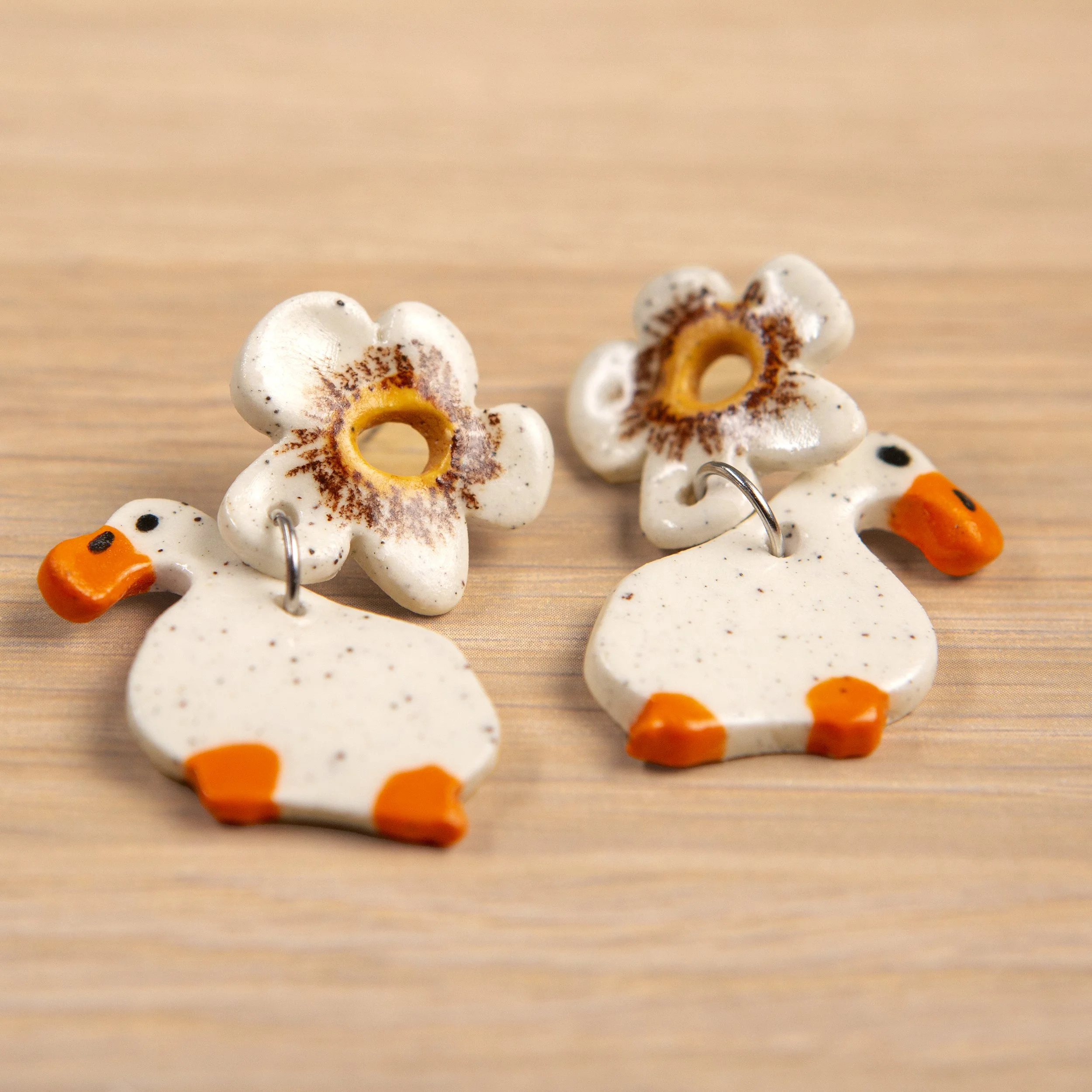 Handmade 2-tier ceramic white flower & white ducks earrings with surgical steel hooks photographed on a neutral background. (Copy) (Copy)