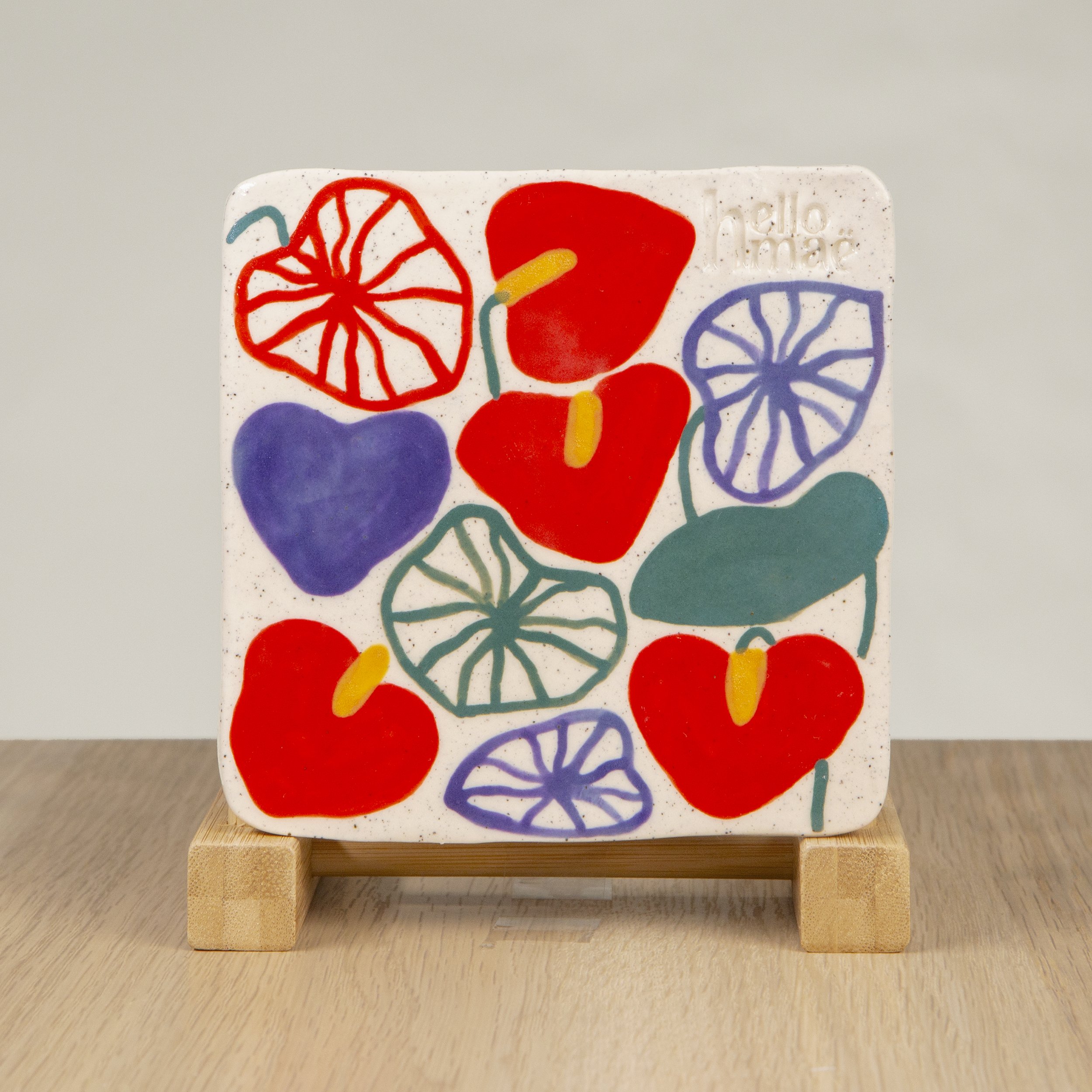 Handmade ceramic coaster featuring a hand-painted Anthurium Flowers design on speckled clay. A sweet addition to your tableware, made in Melbourne by hellomaë.