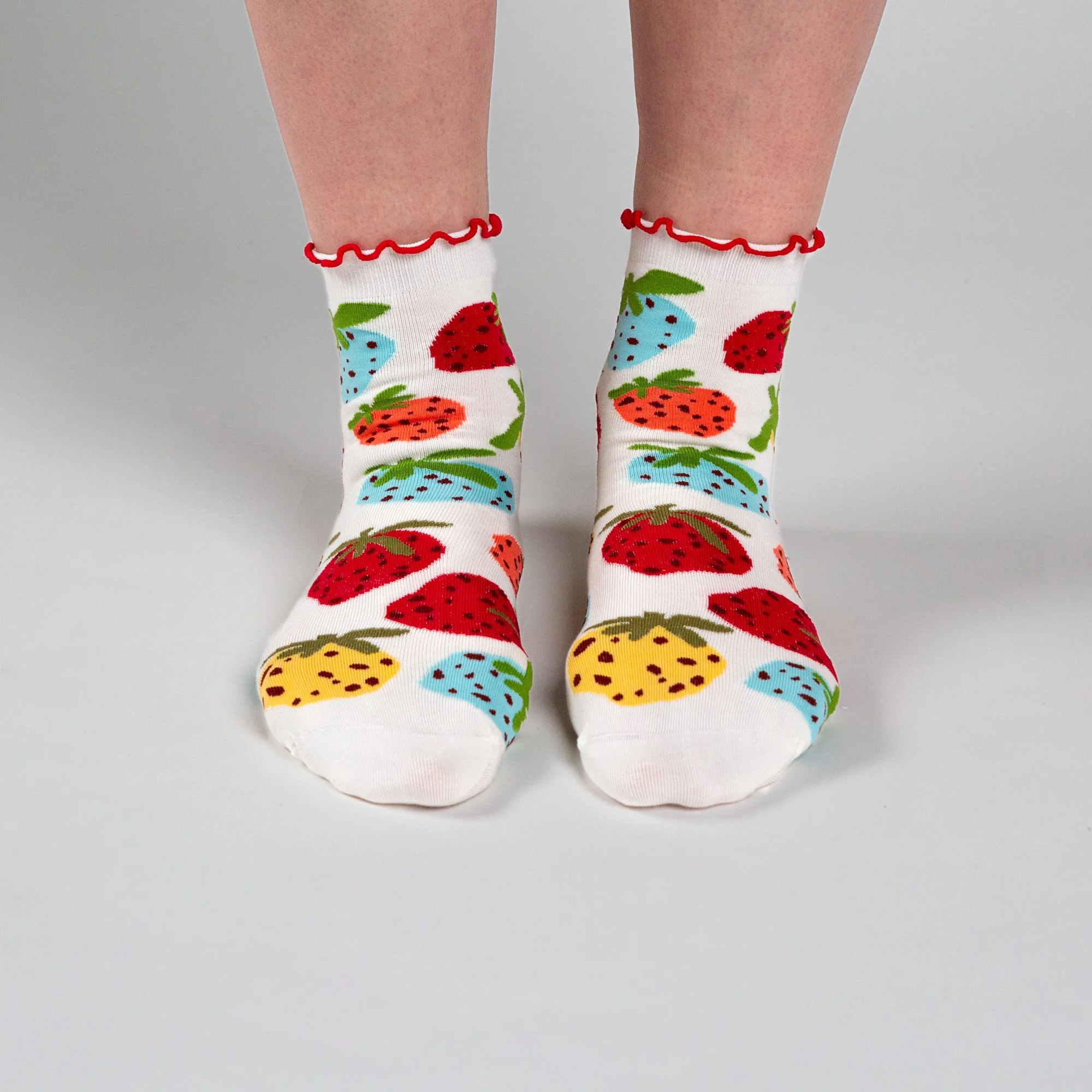 Soft ankle socks featuring the hand-painted Strawberry Dream print and a playful red frill. Comfortable, colourful and perfect for everyday wear.