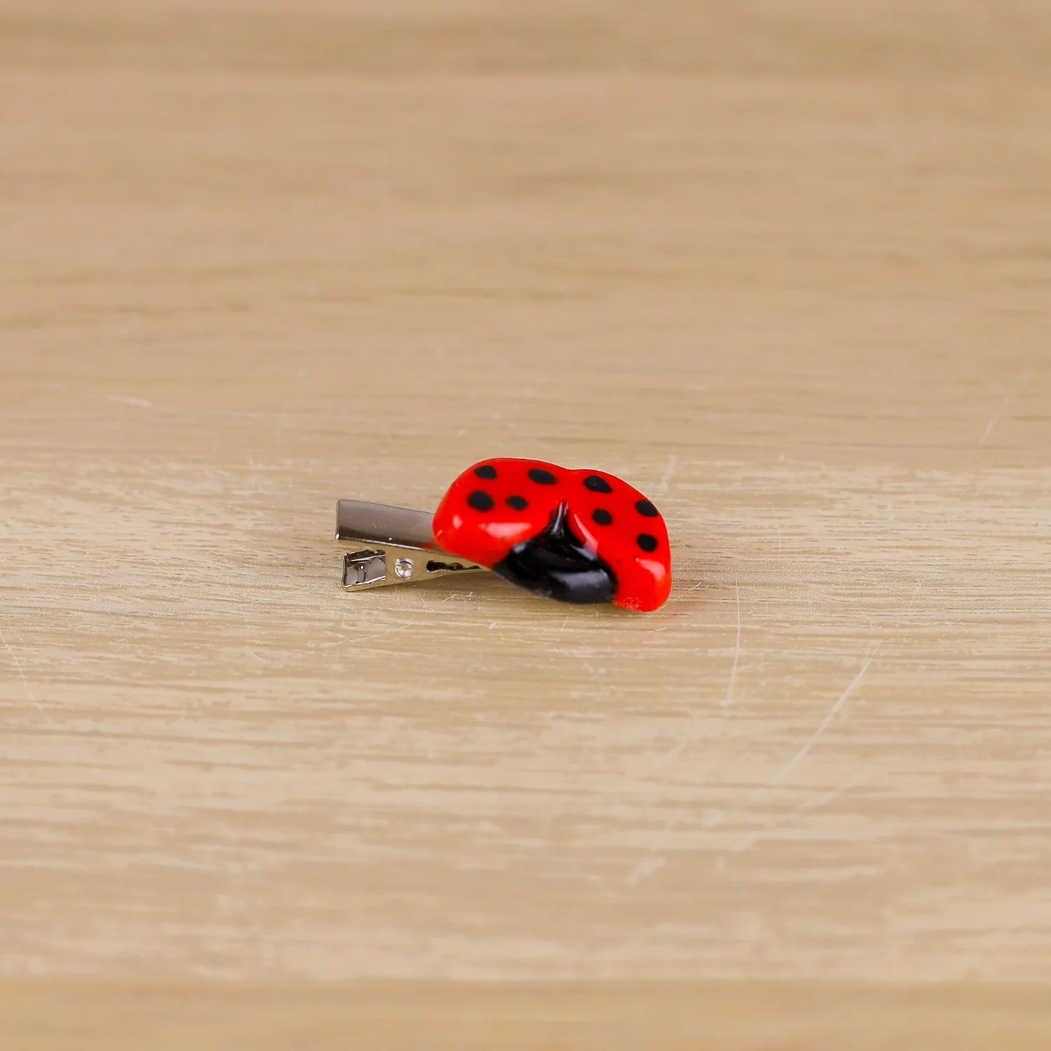 Handmade ceramic ladybug hair clip on silver alligator clip by Hello Mae