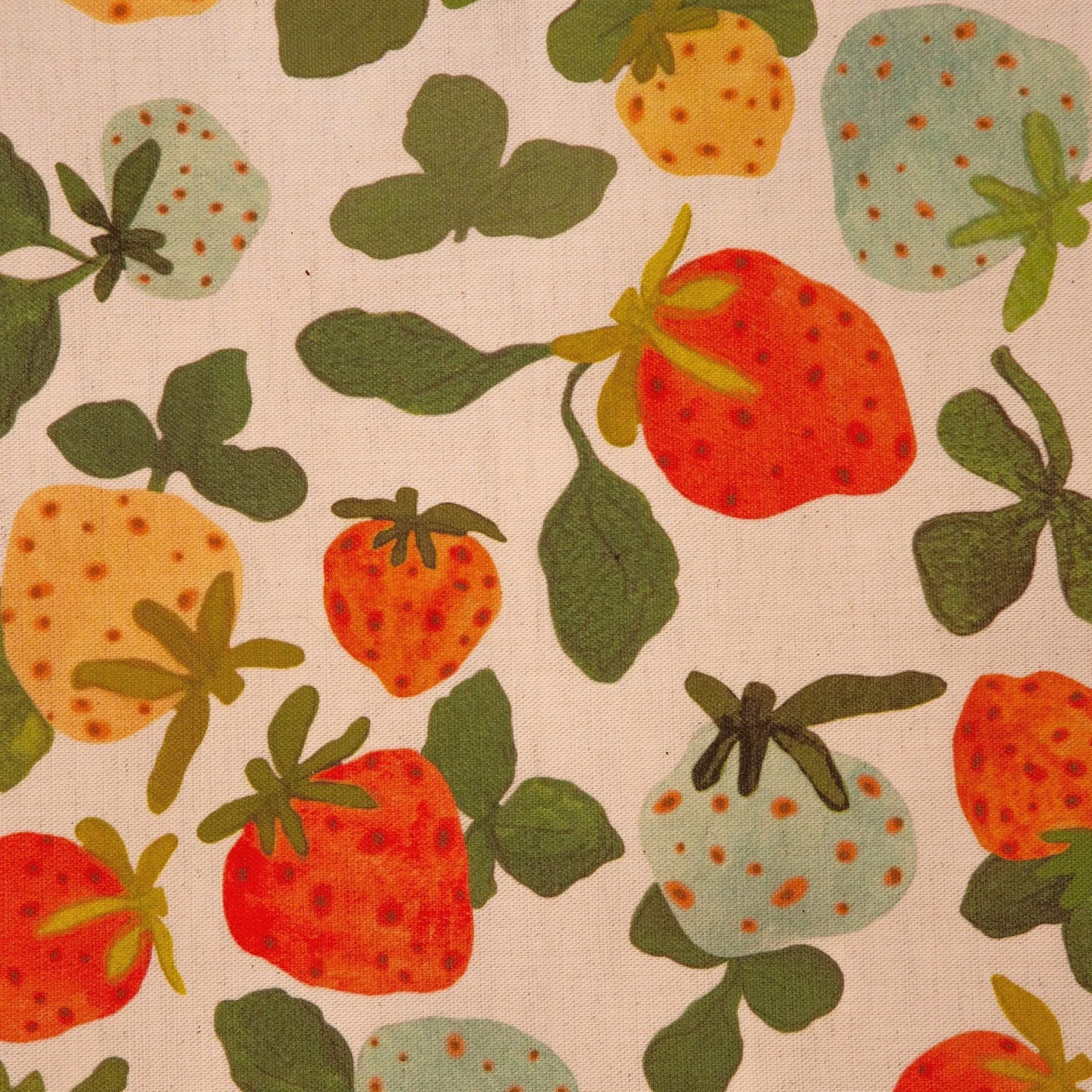 Colourful strawberry tea towel featuring a playful print of yellow, red, pink and blue hand-drawn strawberries.