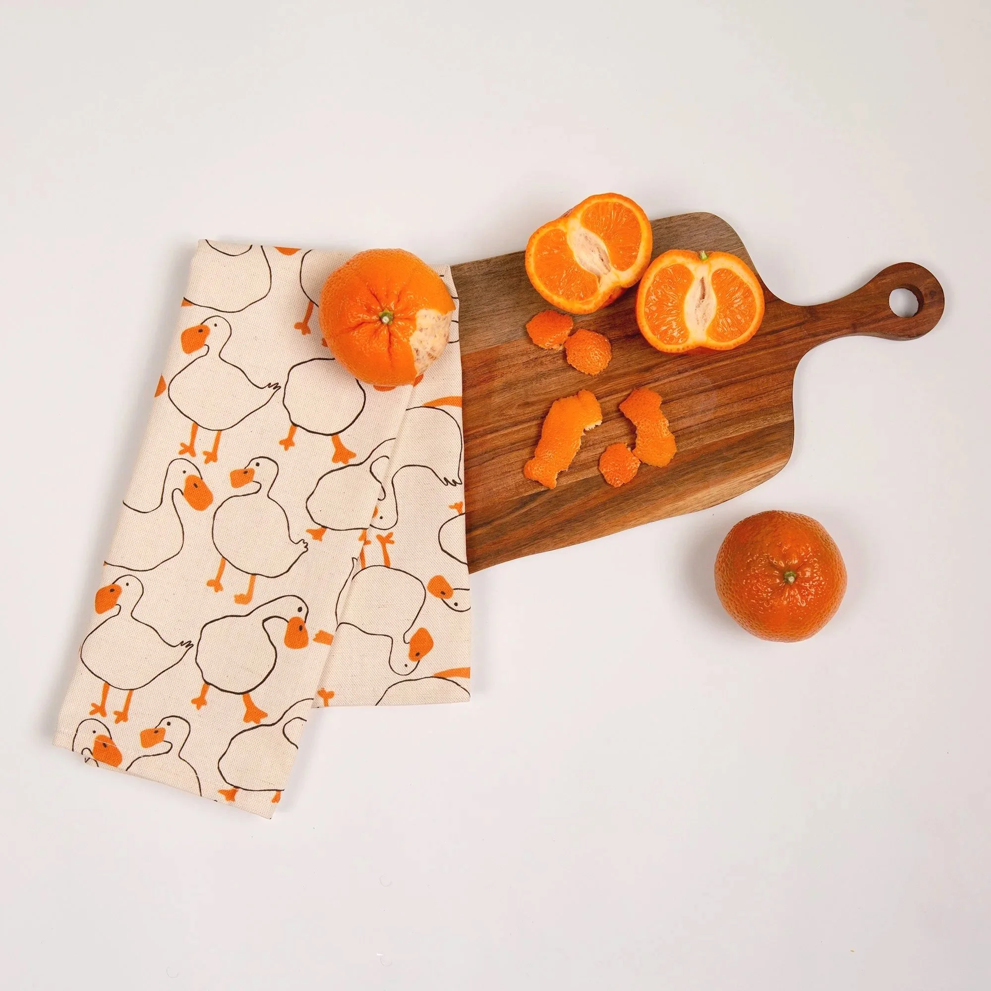 Colourful duck tea towel featuring a playful print of hand-drawn ducks and garden-inspired details.