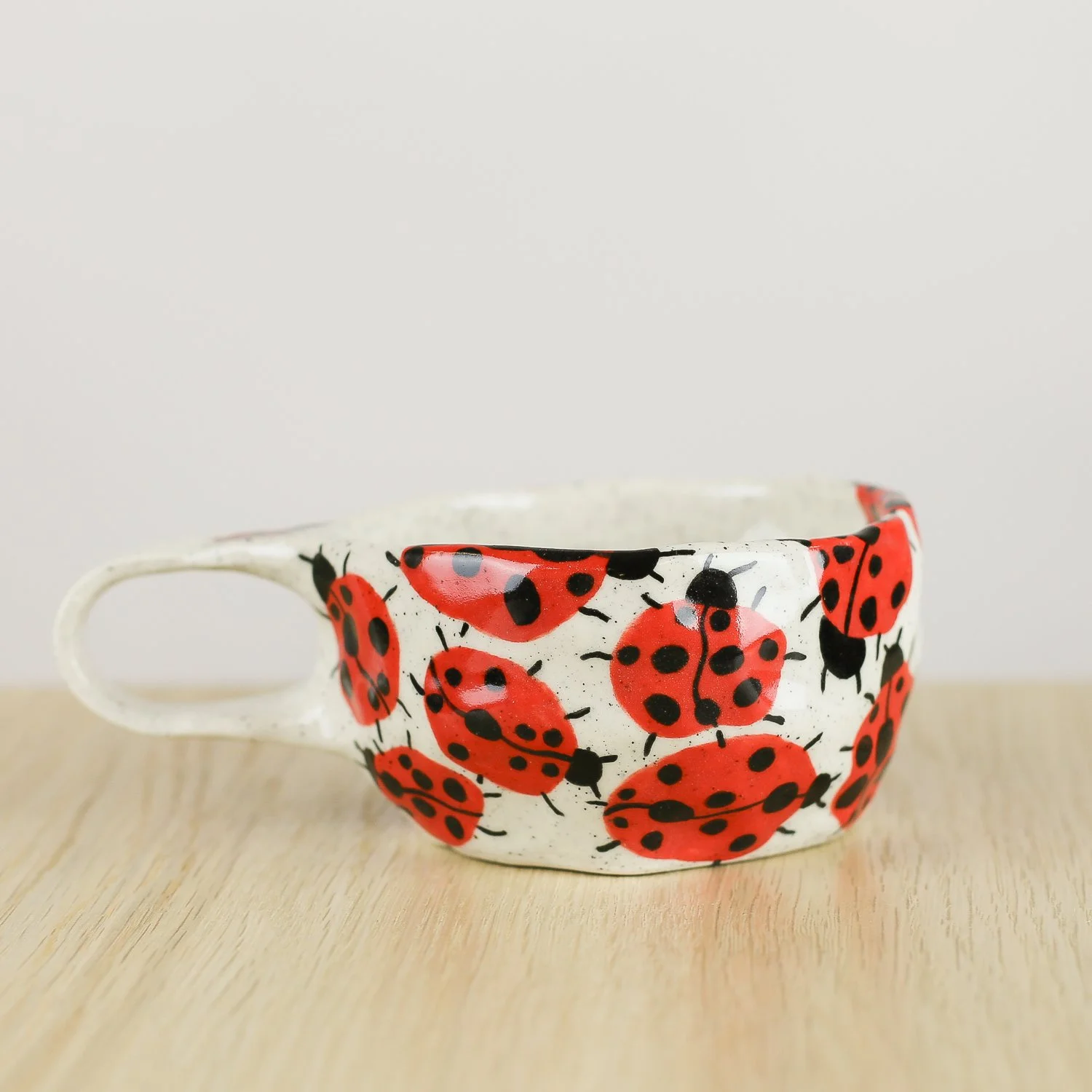 andmade ceramic cup with hand-painted ladybugs. Holds 150ml. A unique, whimsical coffee cup perfect for everyday rituals and thoughtful gifts.
