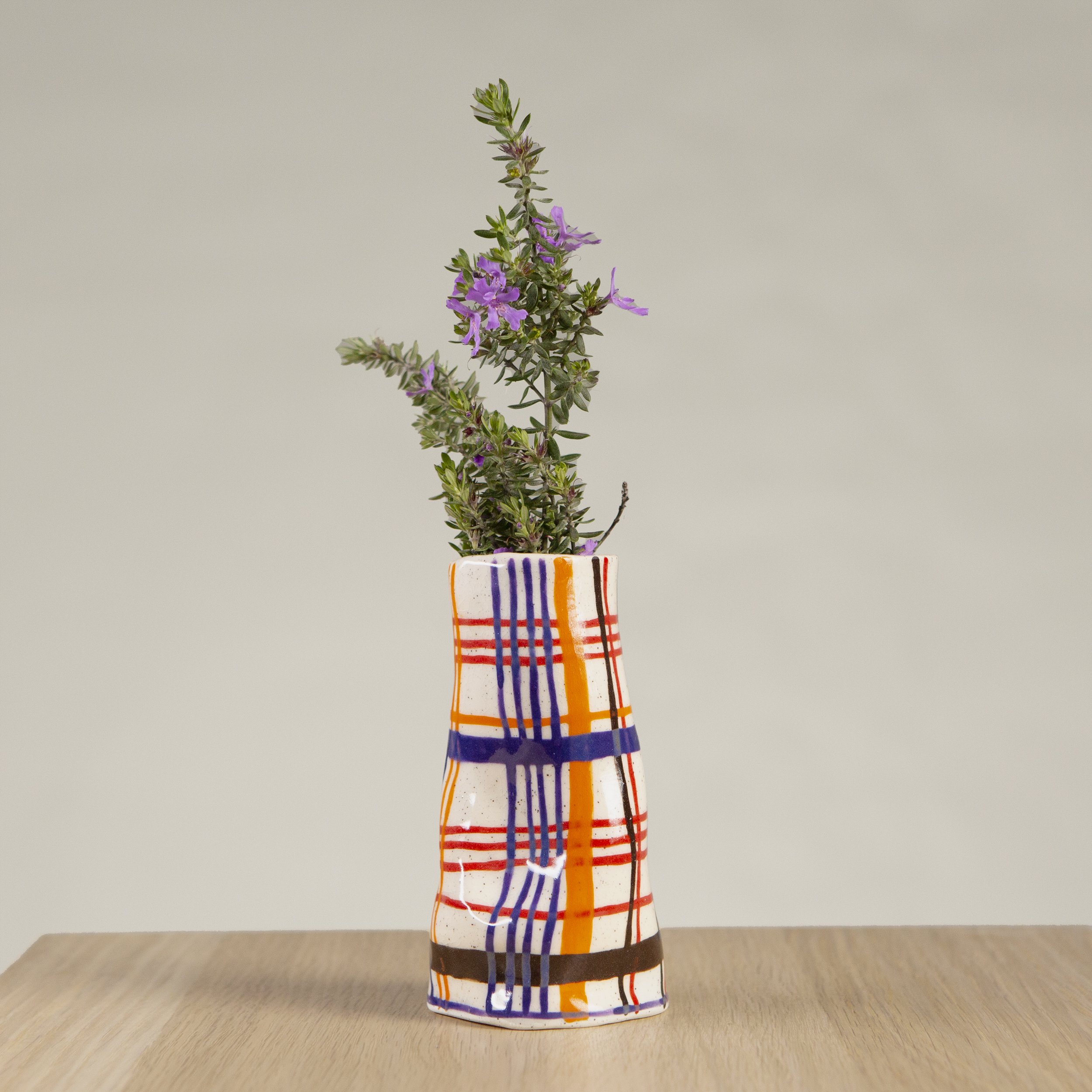 Mini ceramic vase with hand-painted orange, red, blue and chocolate check artwork on speckled clay, handmade in Melbourne by hellomaë