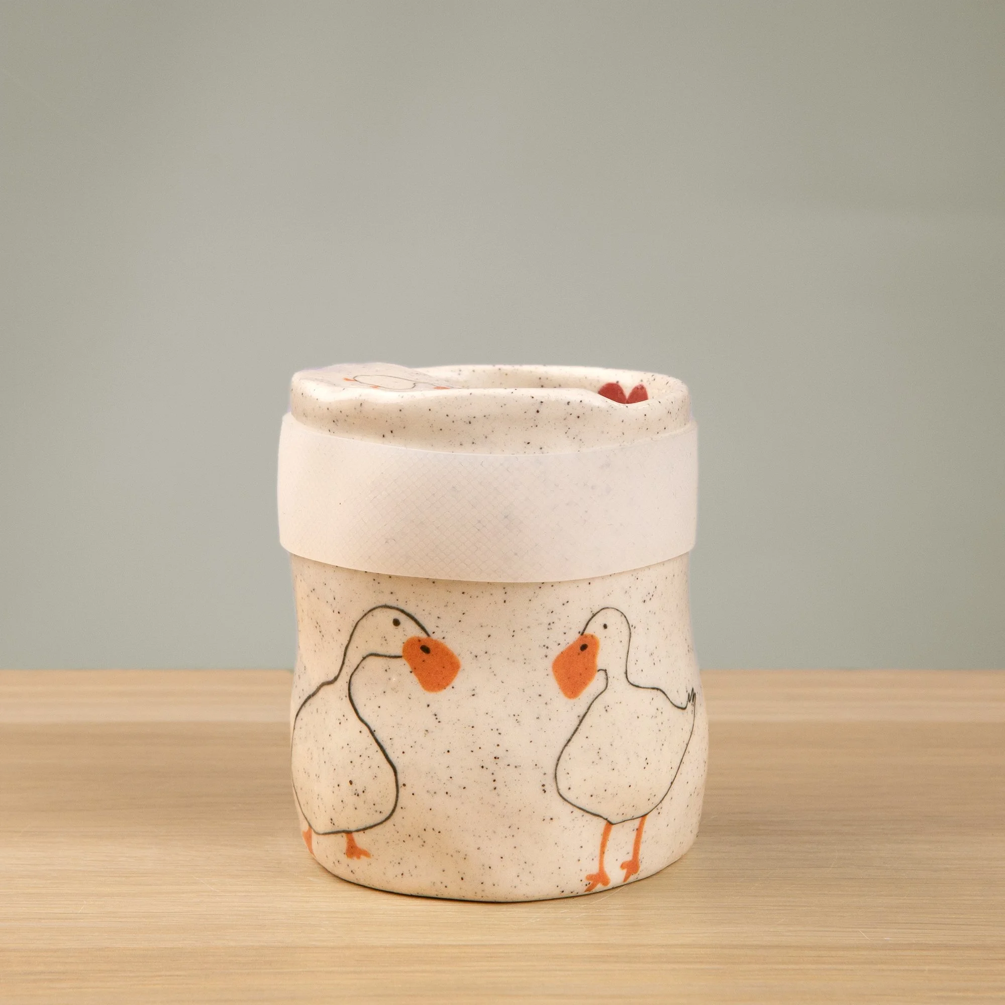 Handmade speckled ceramic loving duck travel cup decorated with cute duck illustrations