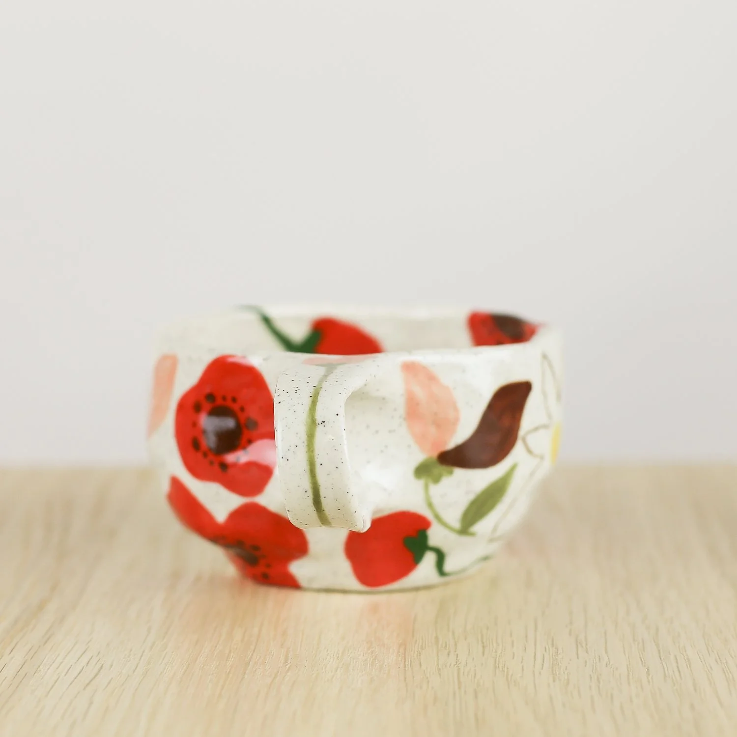 Handmade ceramic cup with hand-painted poppies, daisies and sweet pea flowers. Holds 150ml. A unique floral coffee cup for everyday rituals.