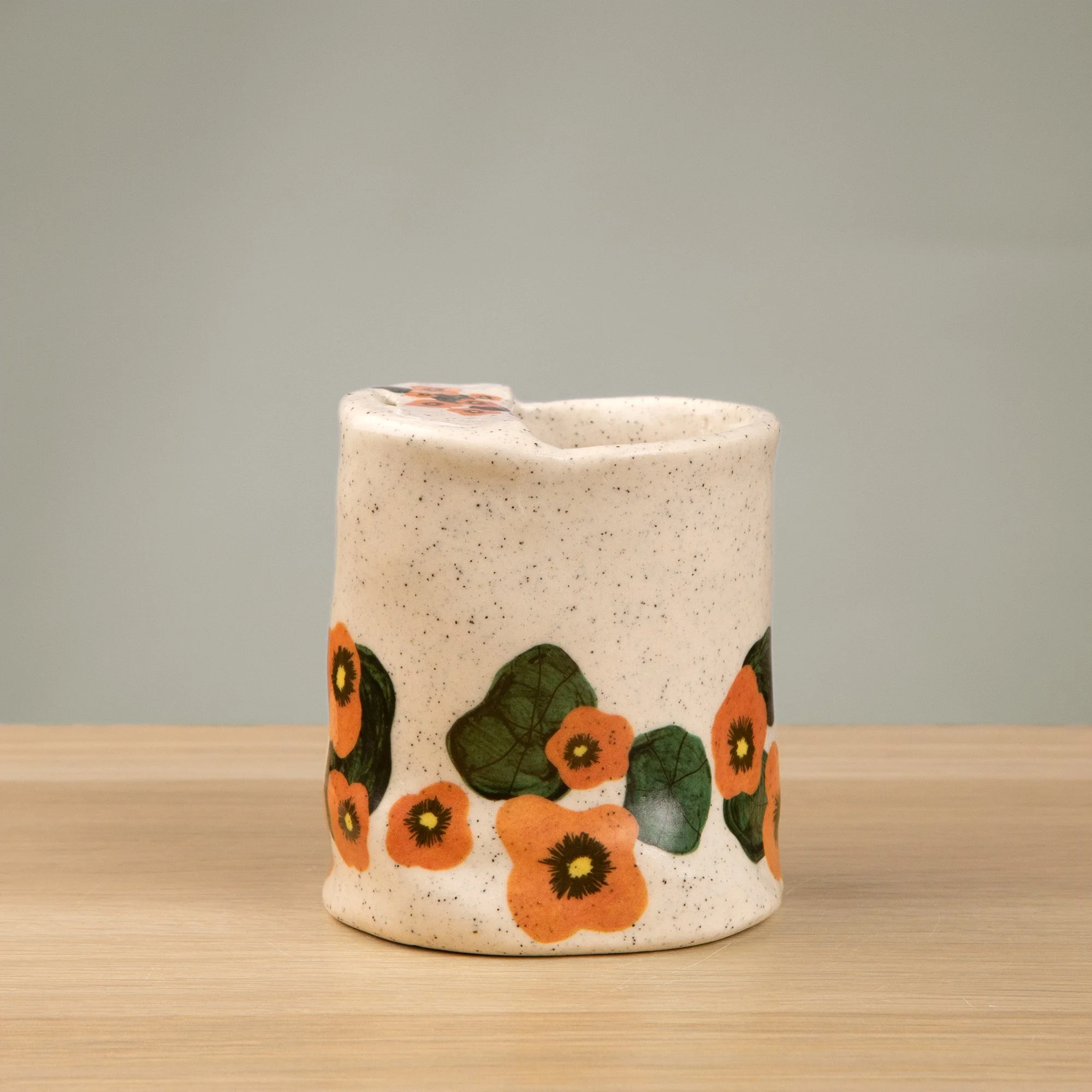 Handmade speckled ceramic nasturtium travel cup decorated with sweet nasturtiums