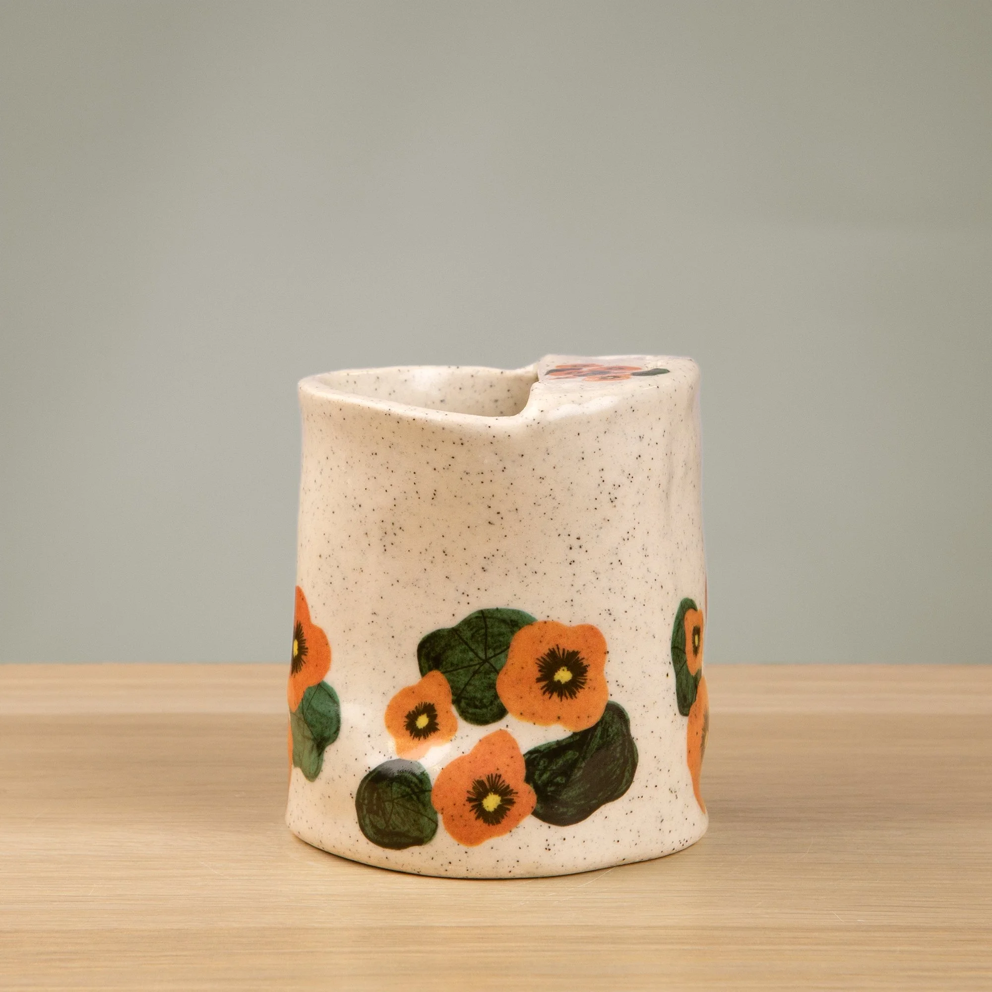 Handmade speckled ceramic nasturtium travel cup decorated with sweet nasturtiums