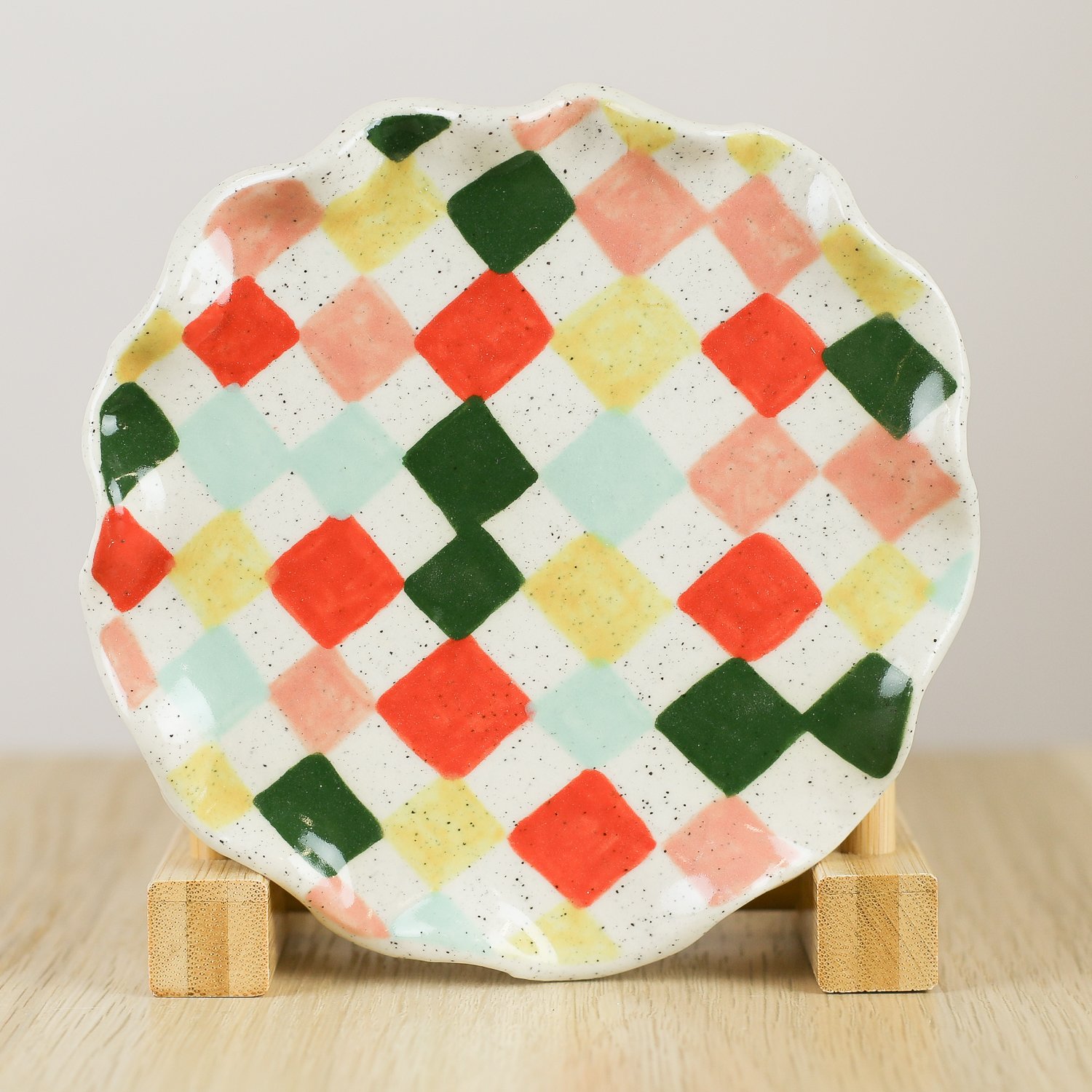 Handmade ceramic saucer with colourful check pattern in red pink yellow and blue, 13.5cm small plate by hellomae