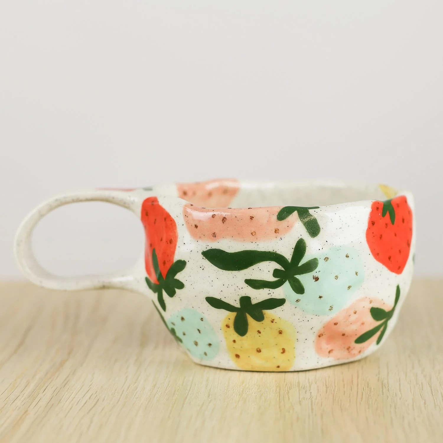 Handmade ceramic mug with colourful strawberries in red pink yellow and blue, 300ml mug by Hello Mae