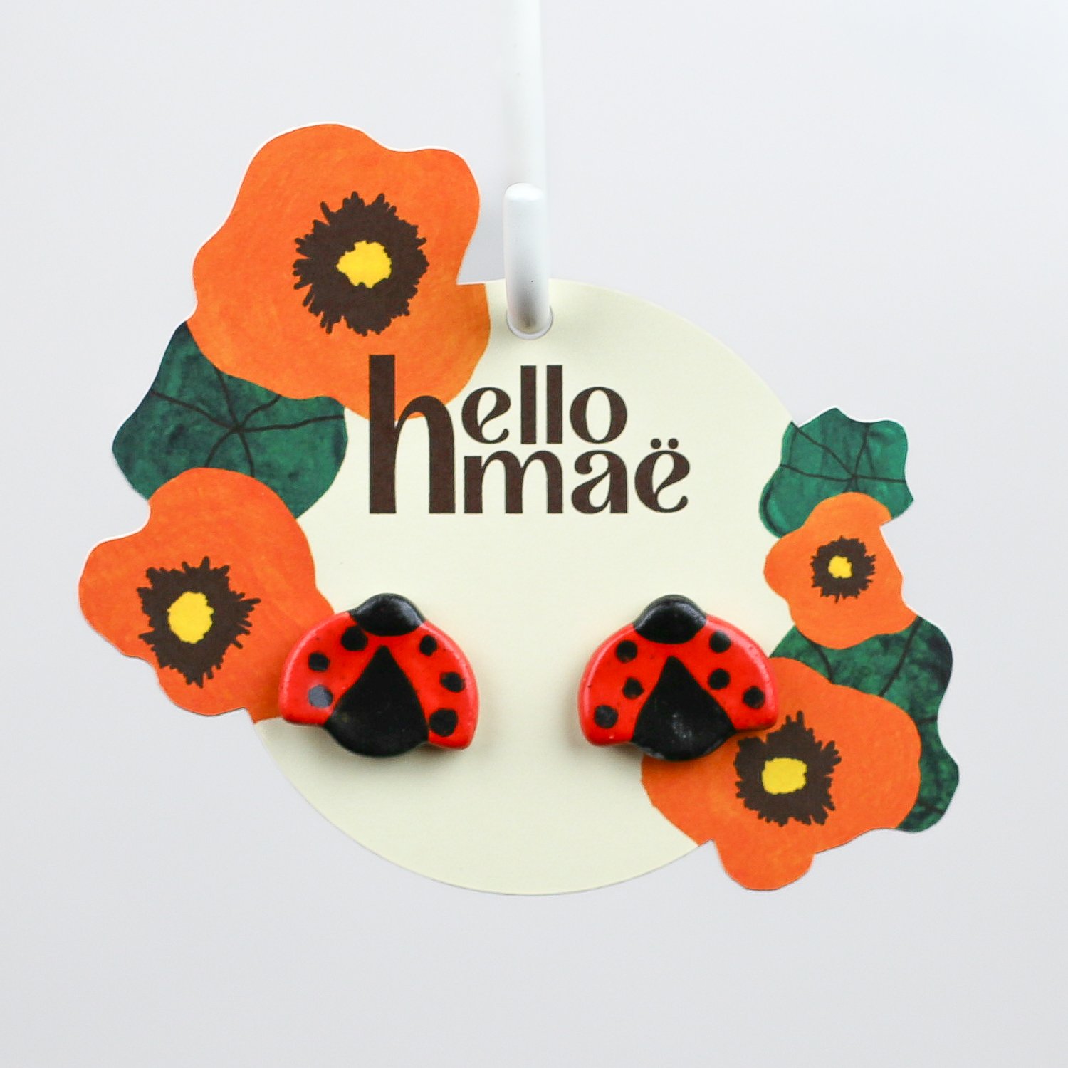 Handmade ceramic ladybug stud earrings with surgical steel posts by hellomae