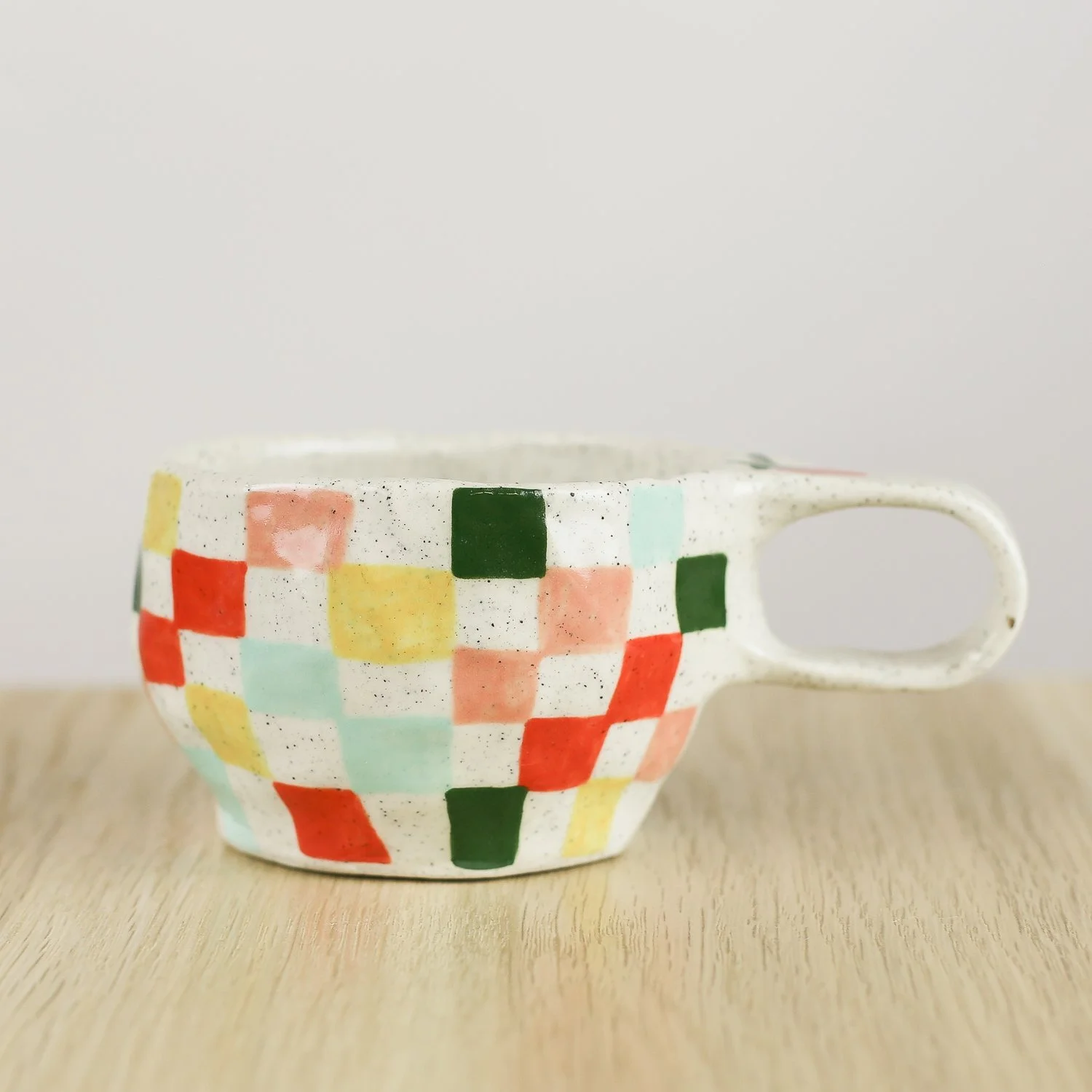 Handmade ceramic cup with colourful check pattern in red pink yellow and blue, 150ml coffee cup by Hello Mae