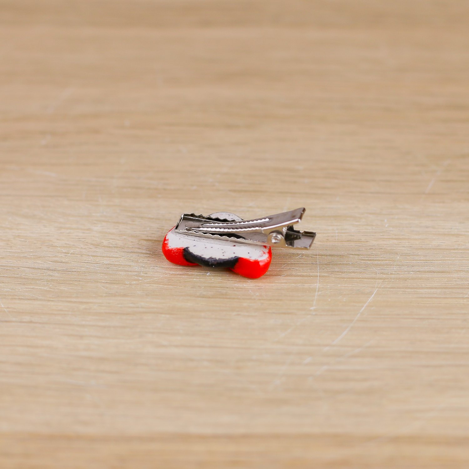 Handmade ceramic ladybug hair clip on silver alligator clip by Hello Mae