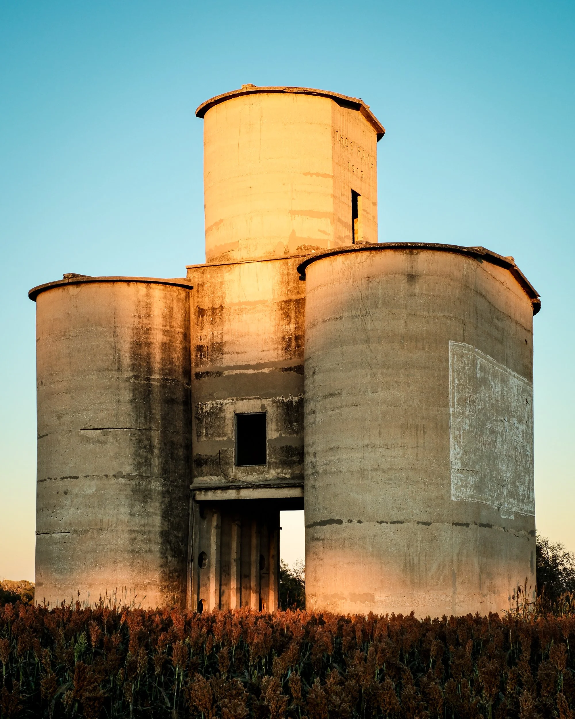 Built in 1915 this Grain Elevator now Stands Abandoned in a Kansas Farm Field. 