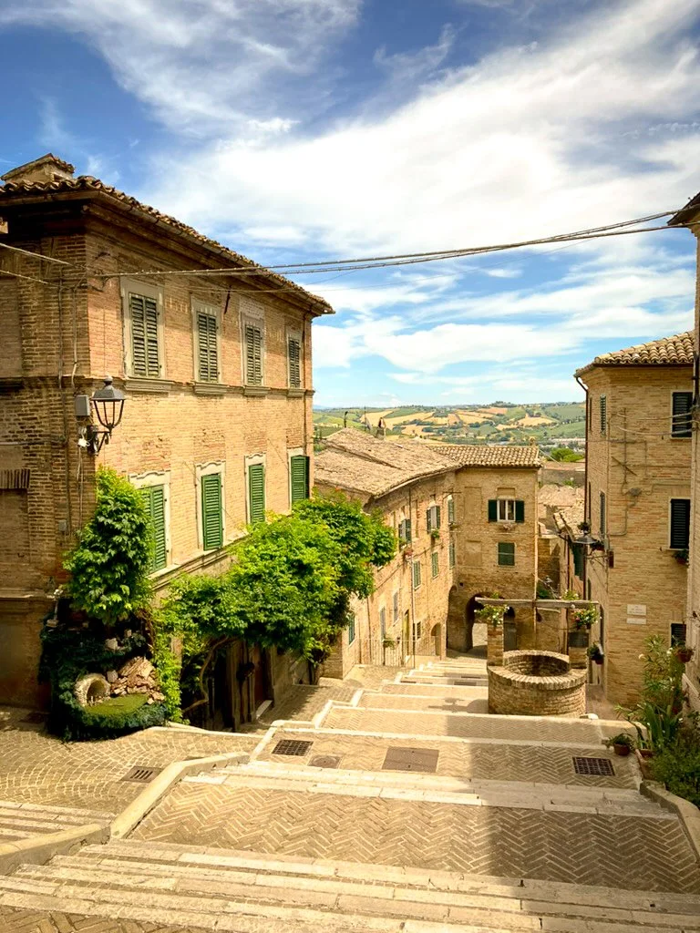 hilltop town in italy with spectacular views of le marche countryside on a sunny day