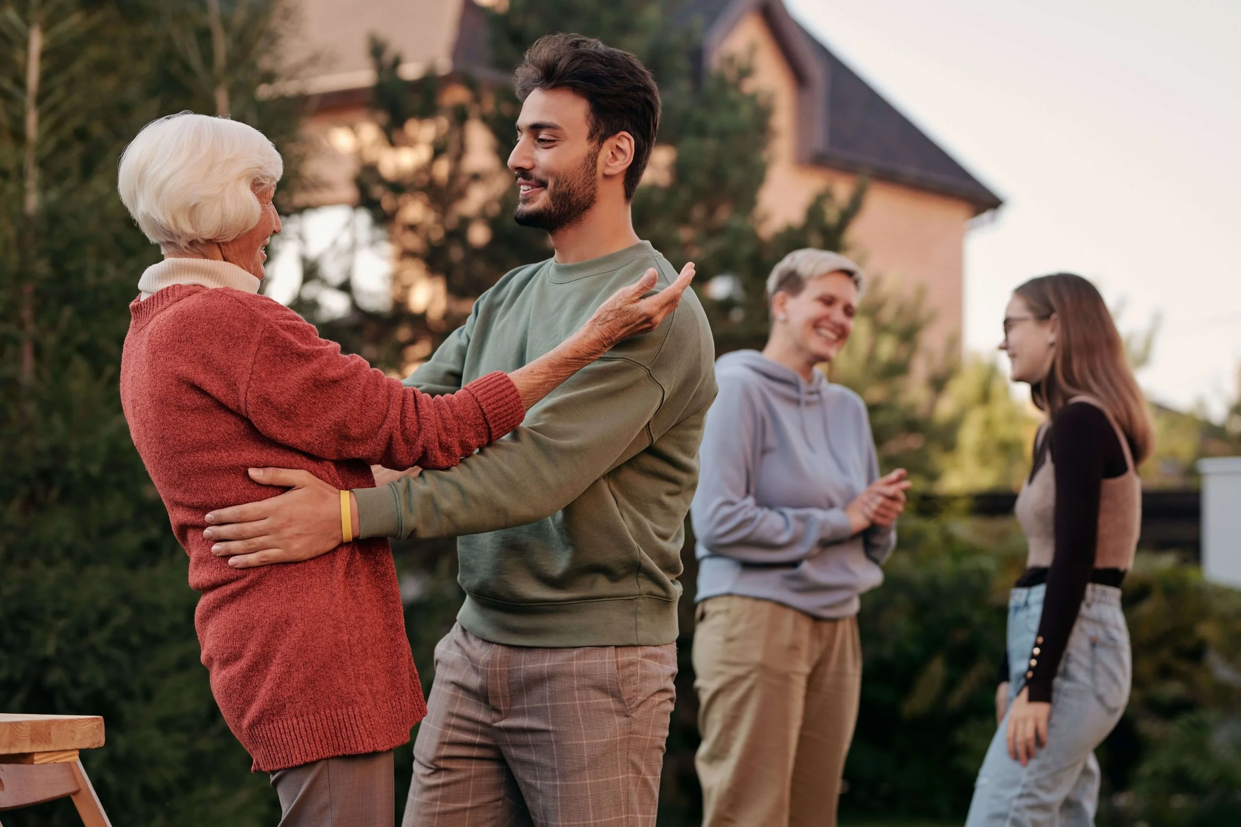 A man and woman greet each other warmly with a hug while others chat in the background. Is setting boundaries with family members something you find yourself avoiding? Family therapy in Arcadia, CA can help you set limits while staying connected.