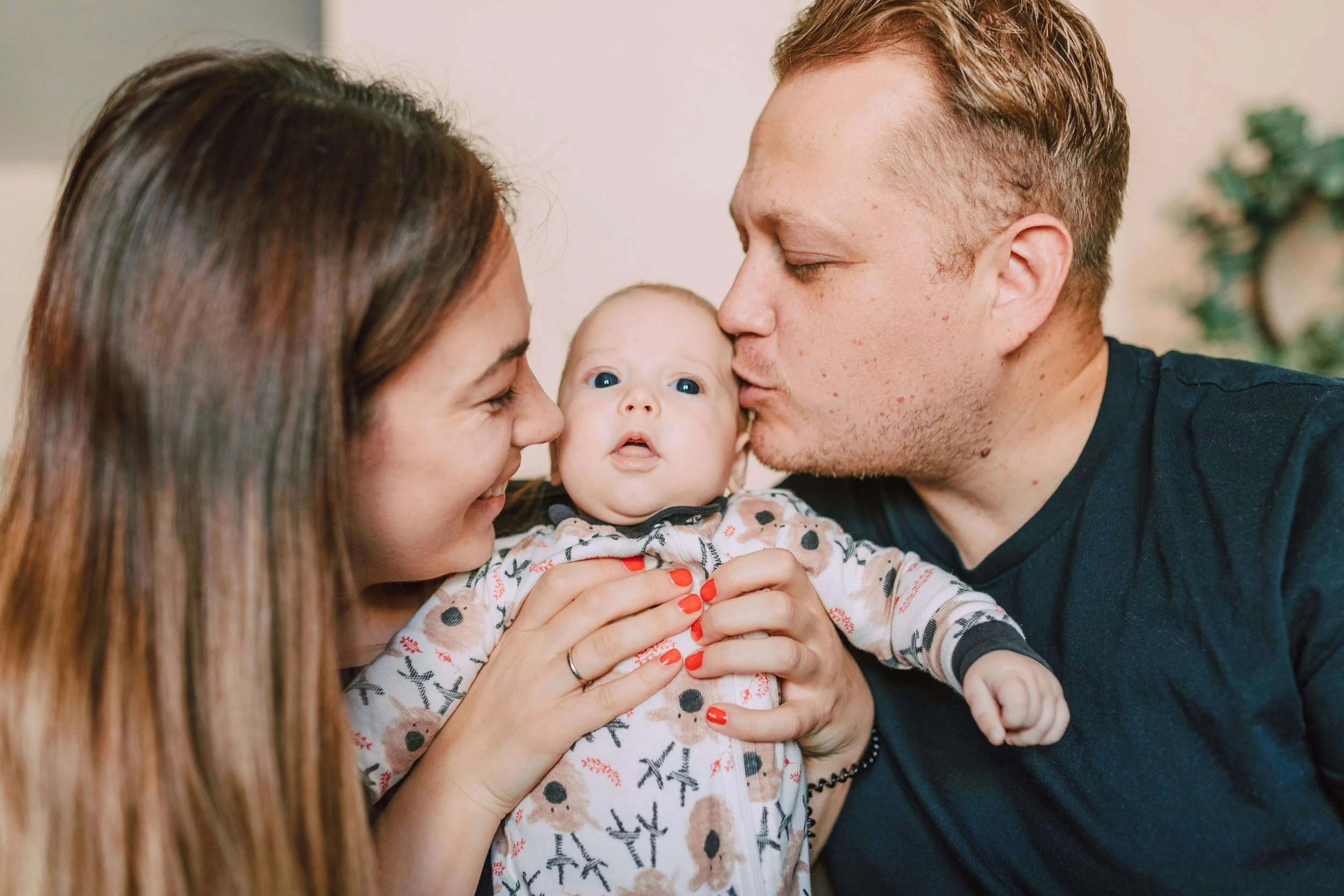 Two parents kiss their baby’s cheeks while holding them close. Do tender moments like this also come with questions about how parenthood has changed your relationship? Couples therapy in Arcadia, CA, can support you in rebuilding closeness.