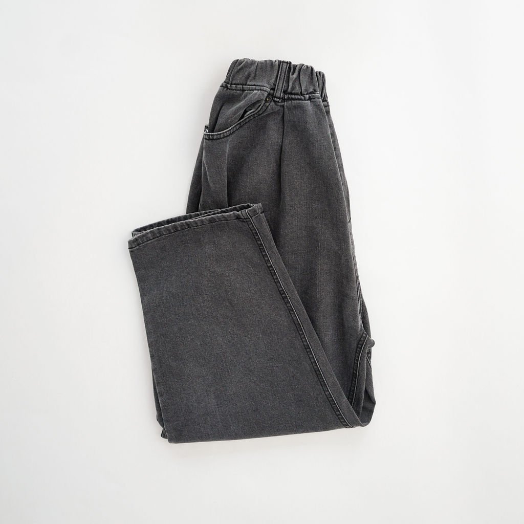 Flat lay of relaxed fit elastic waist jeans in washed black, showcasing the relaxed fit, tapered leg, and elastic waistband for ultimate comfort